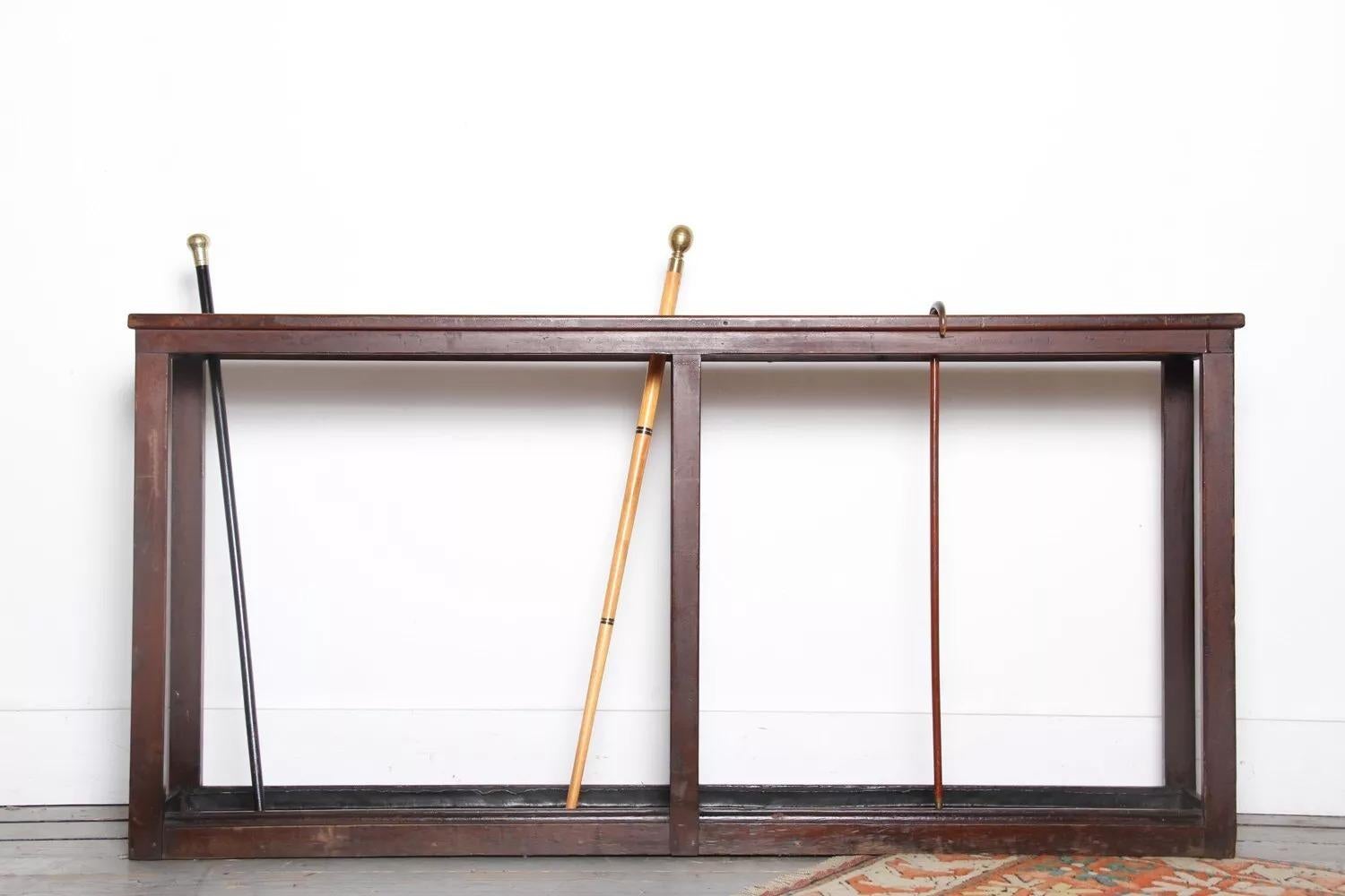 Large Vintage Umbrella and Stick Stand

This is a large late antique stick or umbrella stand. The antique stand has two large sections (each 68Wx15D) to store vast amounts of umbrellas and sticks. It is complete with two lead drip pans. This