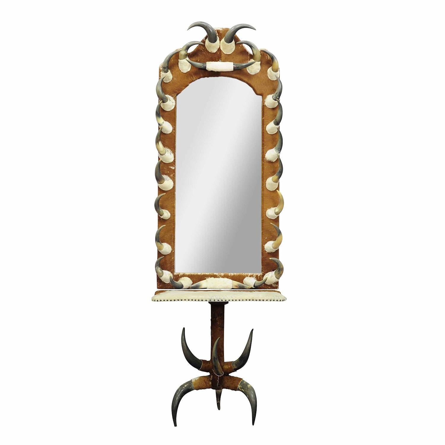 Large hall mirror with cow horn decorations and console table, Austria 1870

A great wall mirror with console table from a noble villa in the Austrian alps. Manufactured in Austria ca. 1870s. The mirror is covered with vintage cow fur and decorated