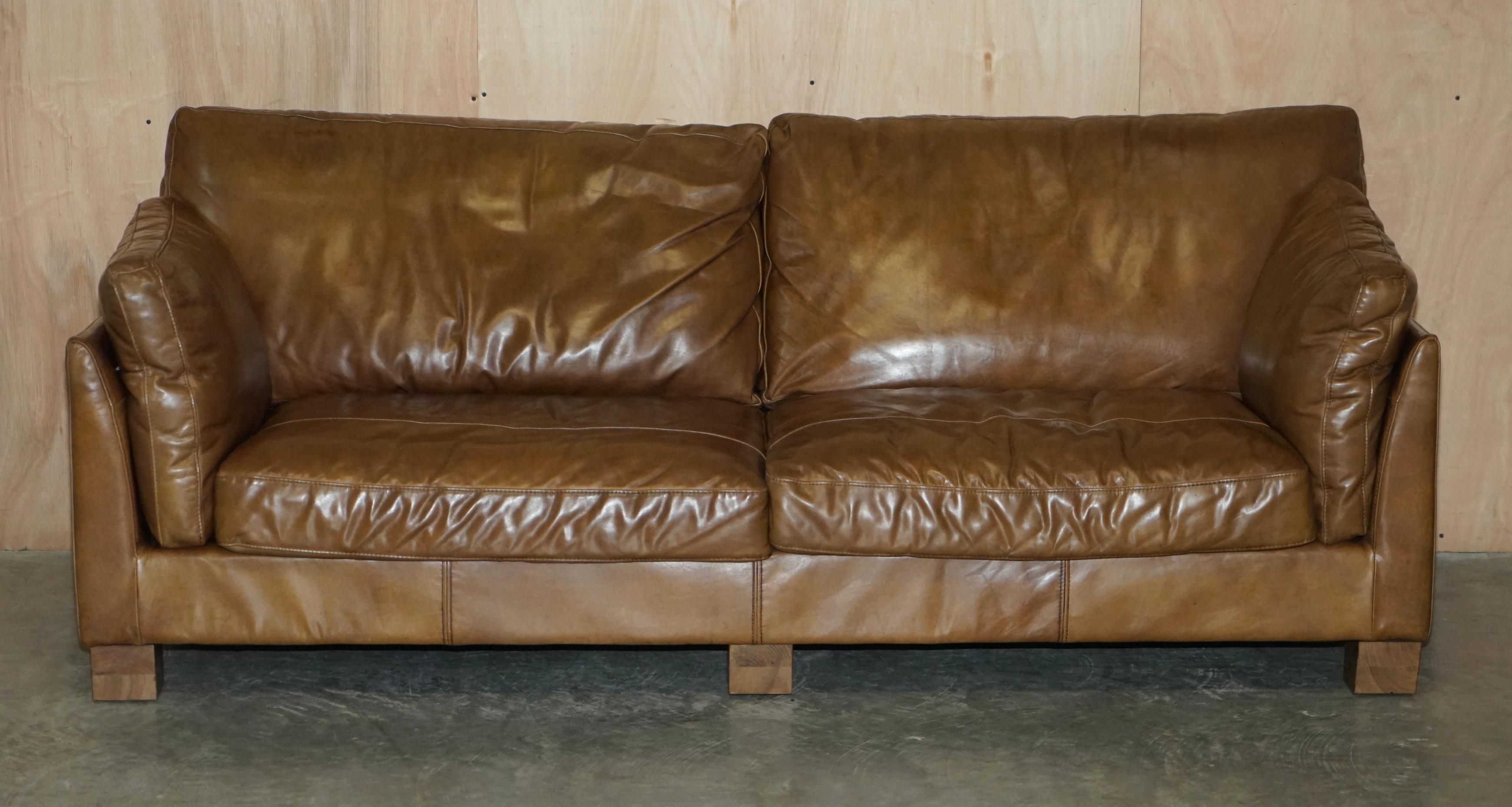 We are delighted to offer for sale this lovely vintage Halo Tan Brown Heritage leather three seat sofa 

The sofa is very comfortable, it has fibre filled cushions which feel like feathers but retain their shape better, it also have the very
