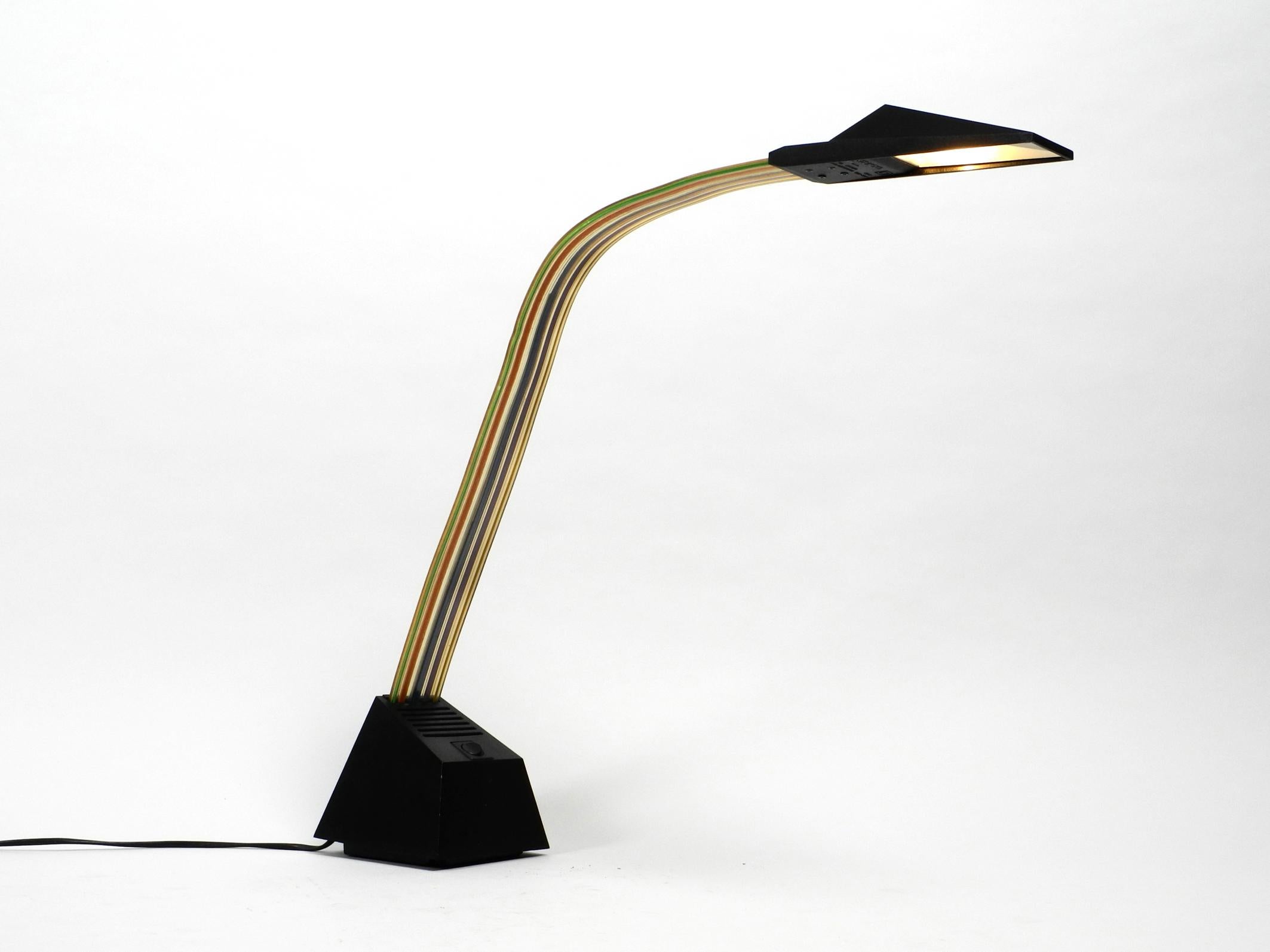 Large 1980s halogen table lamp by Alberto Fraser for Stilnovo. 
The design Classic from the 1980s in postmodern design. Made in Italy. 
Great Minimalist design. Housing is made of metal and plastic. 
The neck is made of transparent, flexible