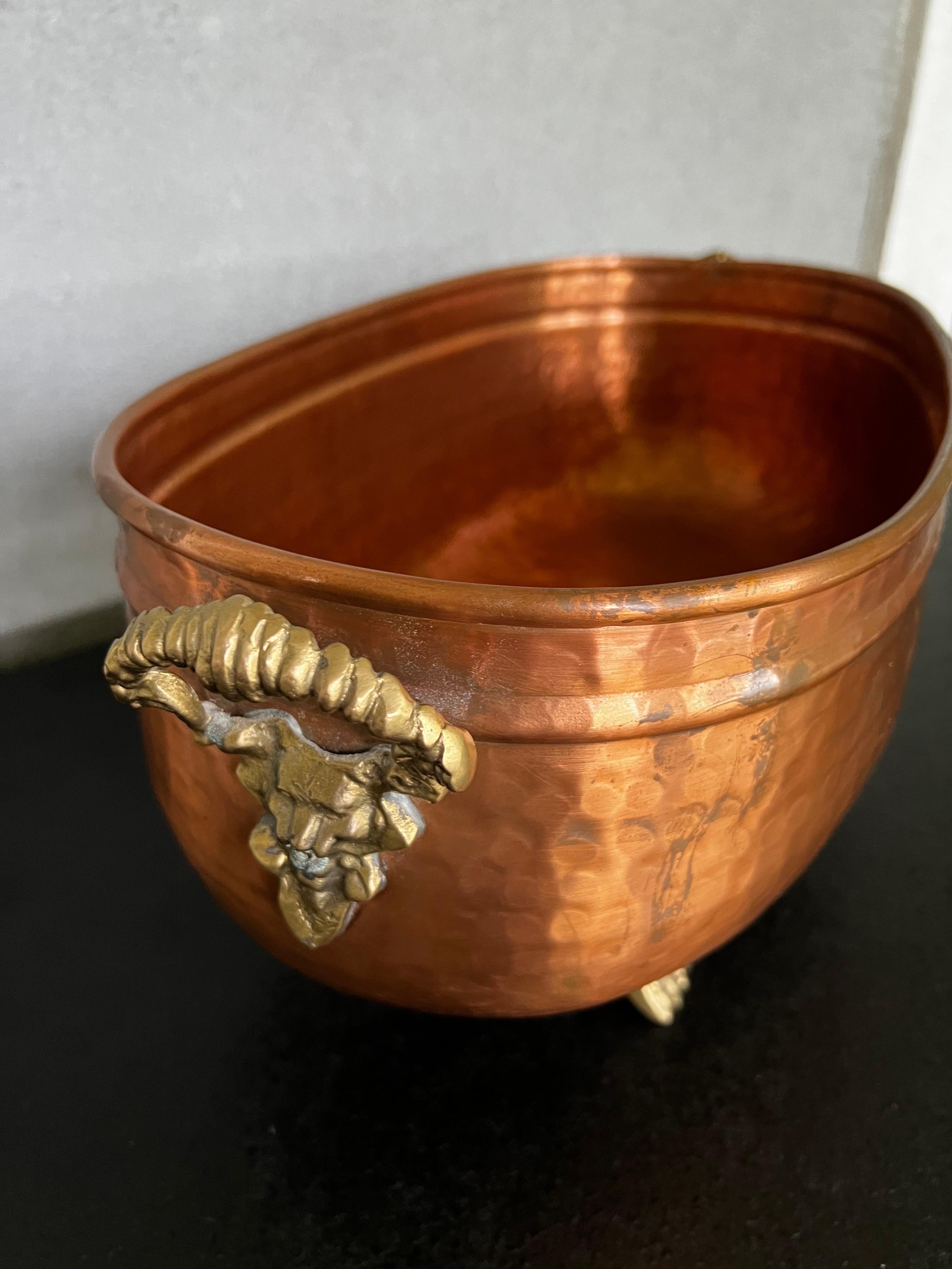 Beautiful hammered copper with brass feet and handles jardiniere, that can be use for ice beverages, plants  or as centerpiece with your favorite items 
Nice details on the elevated feet gives this jardiniere more sophisticated presence 
Its light