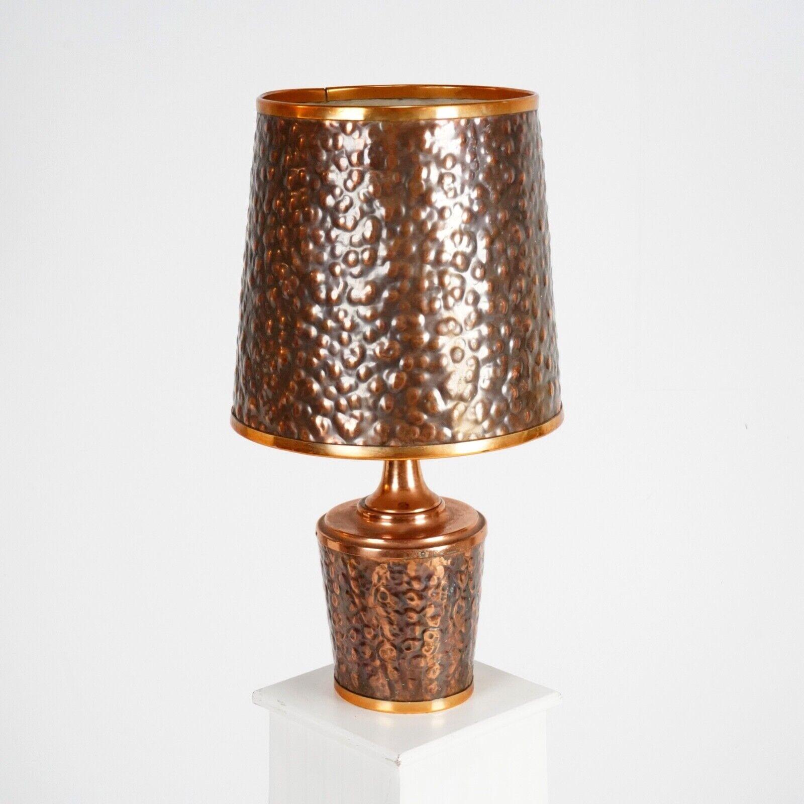 Hand-beaten copper lamp and matching shaded made in Zambia. 
A large table or hall lamp that has a textured bubble/boucle finish. A standout piece that would look fantastic in your home. 
 
Dimensions
 
H 54cm, Diameter shade 24.5cm, diameter base