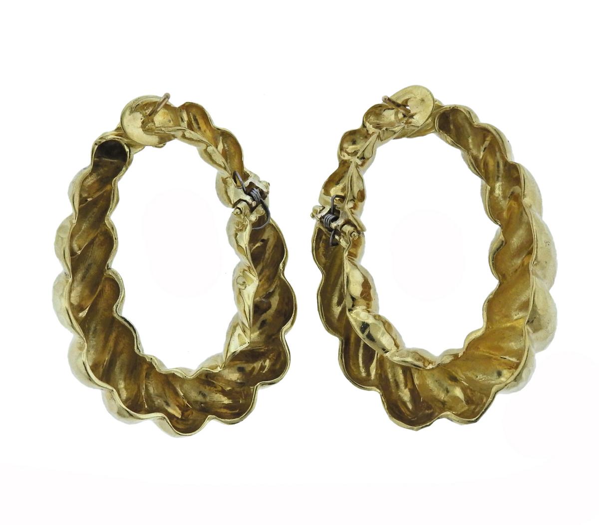  Pair of large 18k hammered gold twisted hoop earrings. Earrings are 45mm x 33mm, widest point of the earring - 11mm, weigh 37 grams. 