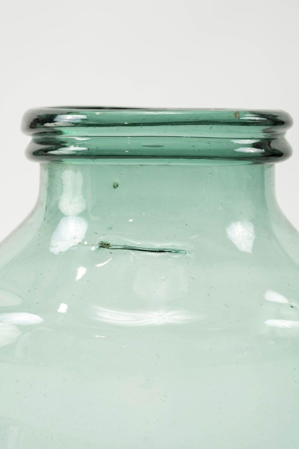 Large hand-blown antique glass jar with bluish-green tint. Three available is varying sizes and shapes (see last three images). Each sold individually and priced $795 each.