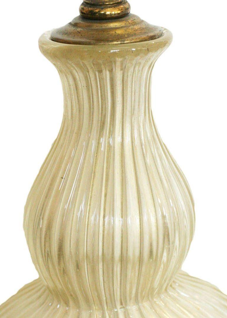Large elegant hand blown semi clear Murano glass table lamp very much in the style of Barovier e Toso. Large round hand blown center piece fixed to a decorative brass base with brass accents. 

32
