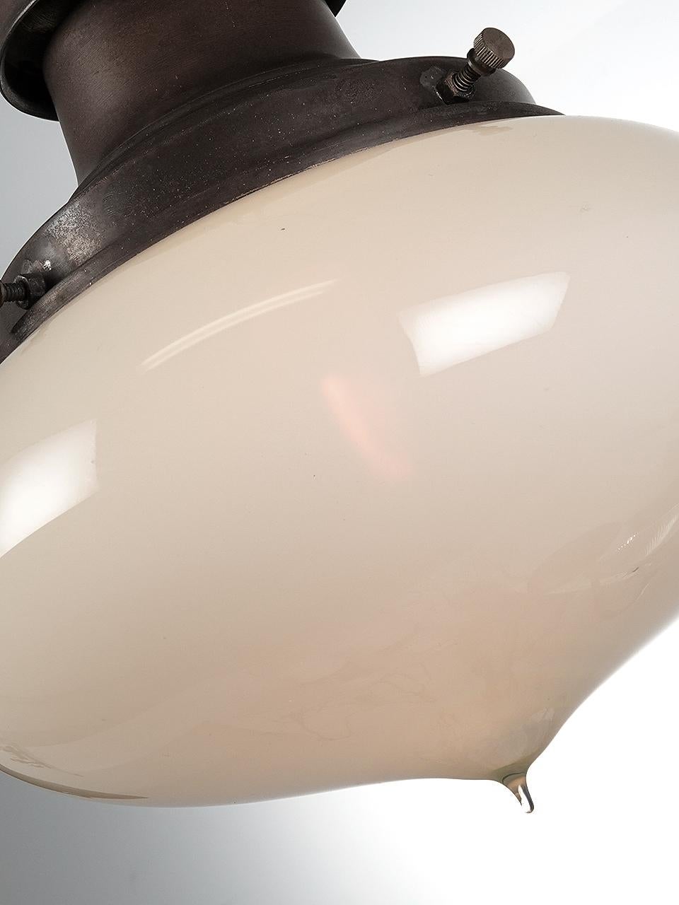 These early elegant hand blown tipped shades are vaseline glass. They have a nice even and warm glow with no filament glair. The fixture uses a Gas Era style shade holder. The large 9.5 inch diameter globe is not only dramatic but has a unique and
