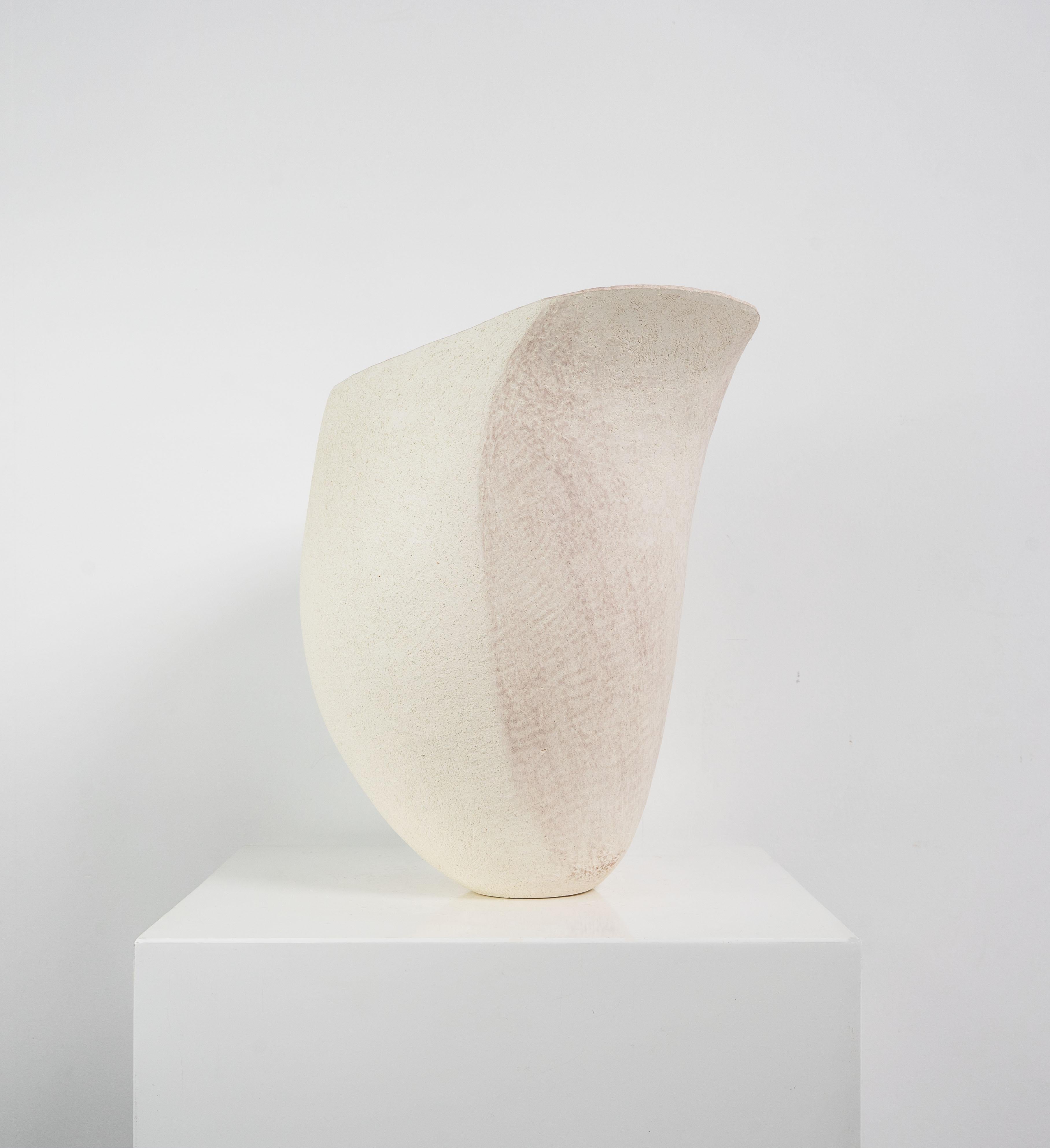 A large vessel hand built in stoneware by Betty Blandino (1927-2011). An asymmetrical form with a lilac coloured panel over a textured surface, impressed with the potter's mark to the base.

Born in London in 1927, Blandino became a full time