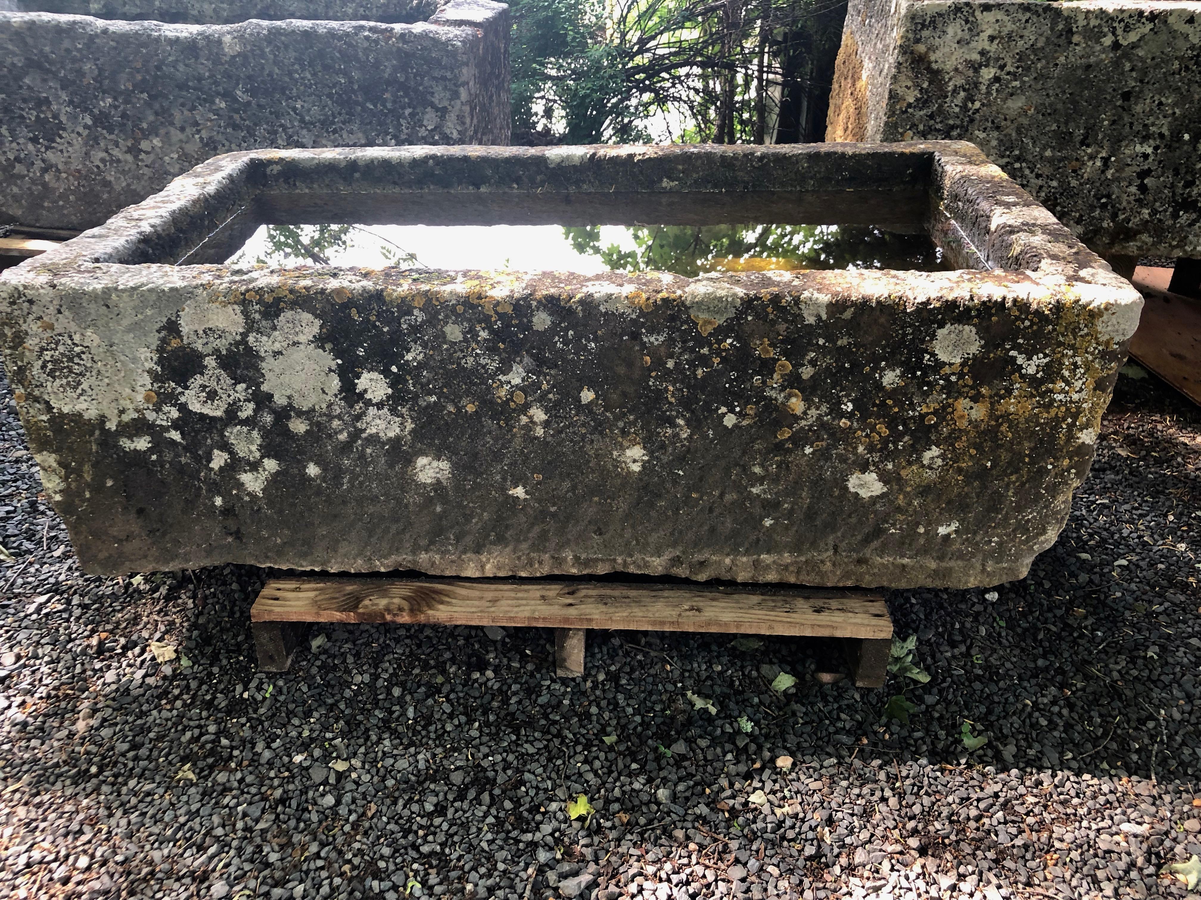 One of the finest troughs sourced on our most recent buying trip to France, this stunning hand carved limestone trough is in excellent antique condition and features a fabulous patina with heavy lichen in white, yellow and orange. It has no cracks