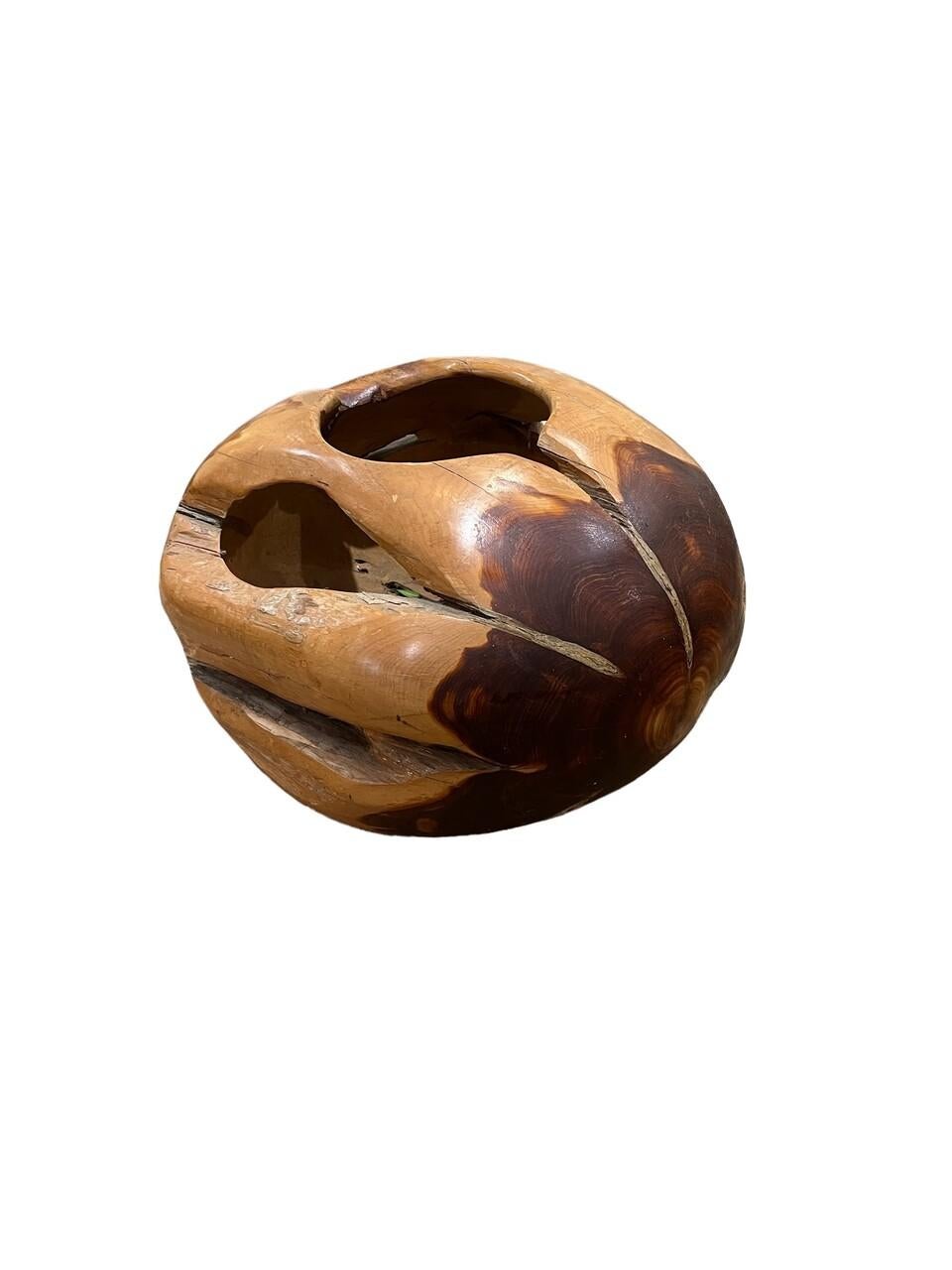 Experience the exquisite craftsmanship of this large hand-carved burl root sphere sculpture. Each curve and contour of the burl wood has been meticulously shaped and polished to perfection, revealing the natural beauty and unique grain patterns