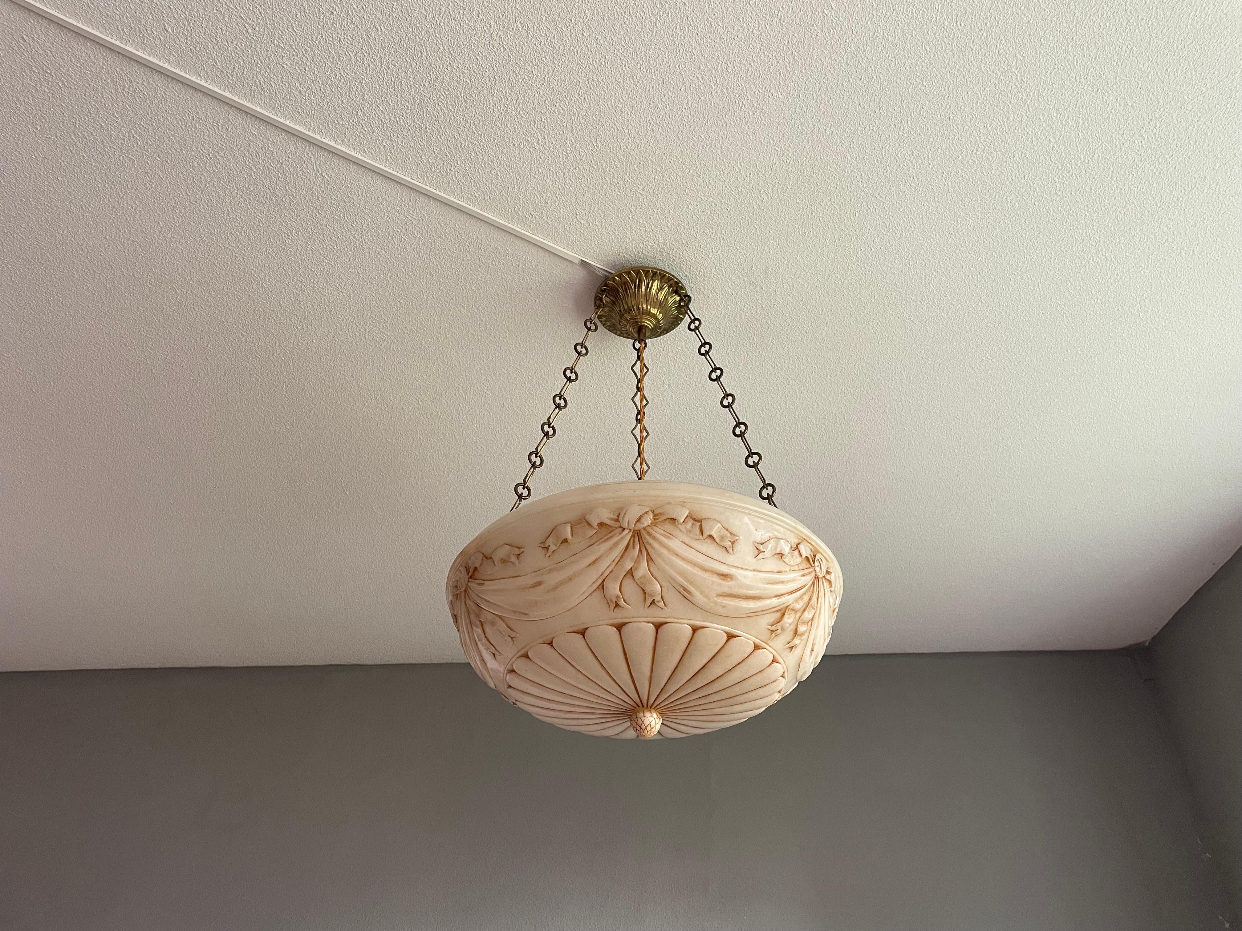 Top class light fixture with a stunning alabaster shade of 18 inches in diameter.

Thanks to its rare design, its large size and its very good condition this antique, three-light alabaster chandelier will bring class and style like no modern light