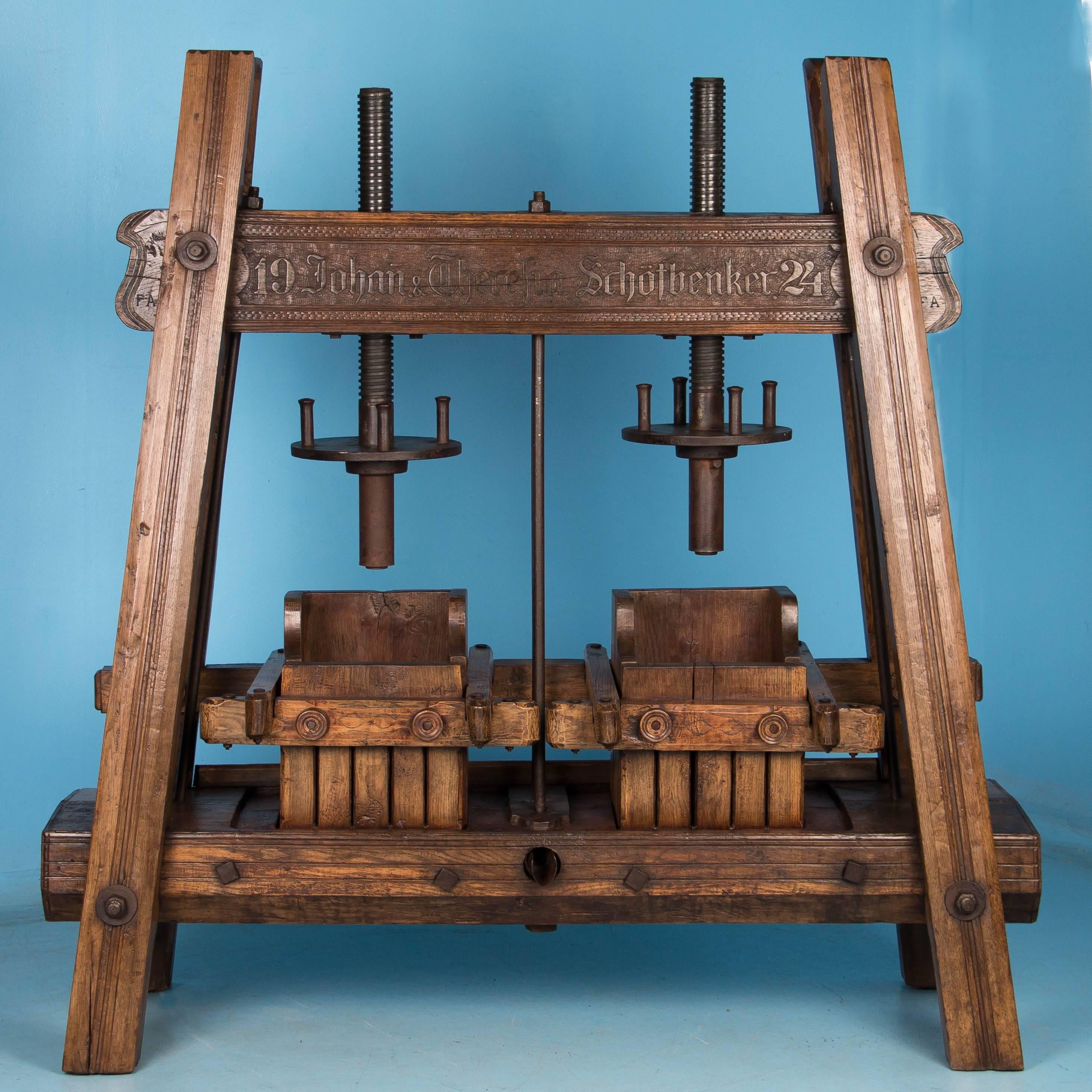 This extremely rare freestanding, dual wine press is handcrafted from solid oak. Used for crushing fruit like grapes for wine or apples for cider, this large, very sturdy press is complete and all original. The large beam holding the cast iron