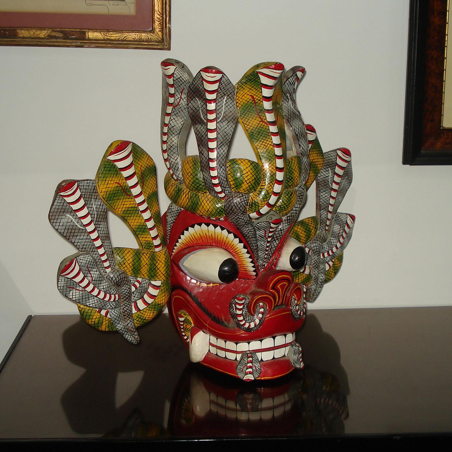 Large Balinese Barong carved and hand-painted wood dance mask of an ornate, colorful mythological creature.
Skilfully hand carved, with large bulging eyes, large teeth, and two snakes protruding from either side of the mouth. Snakes all around the