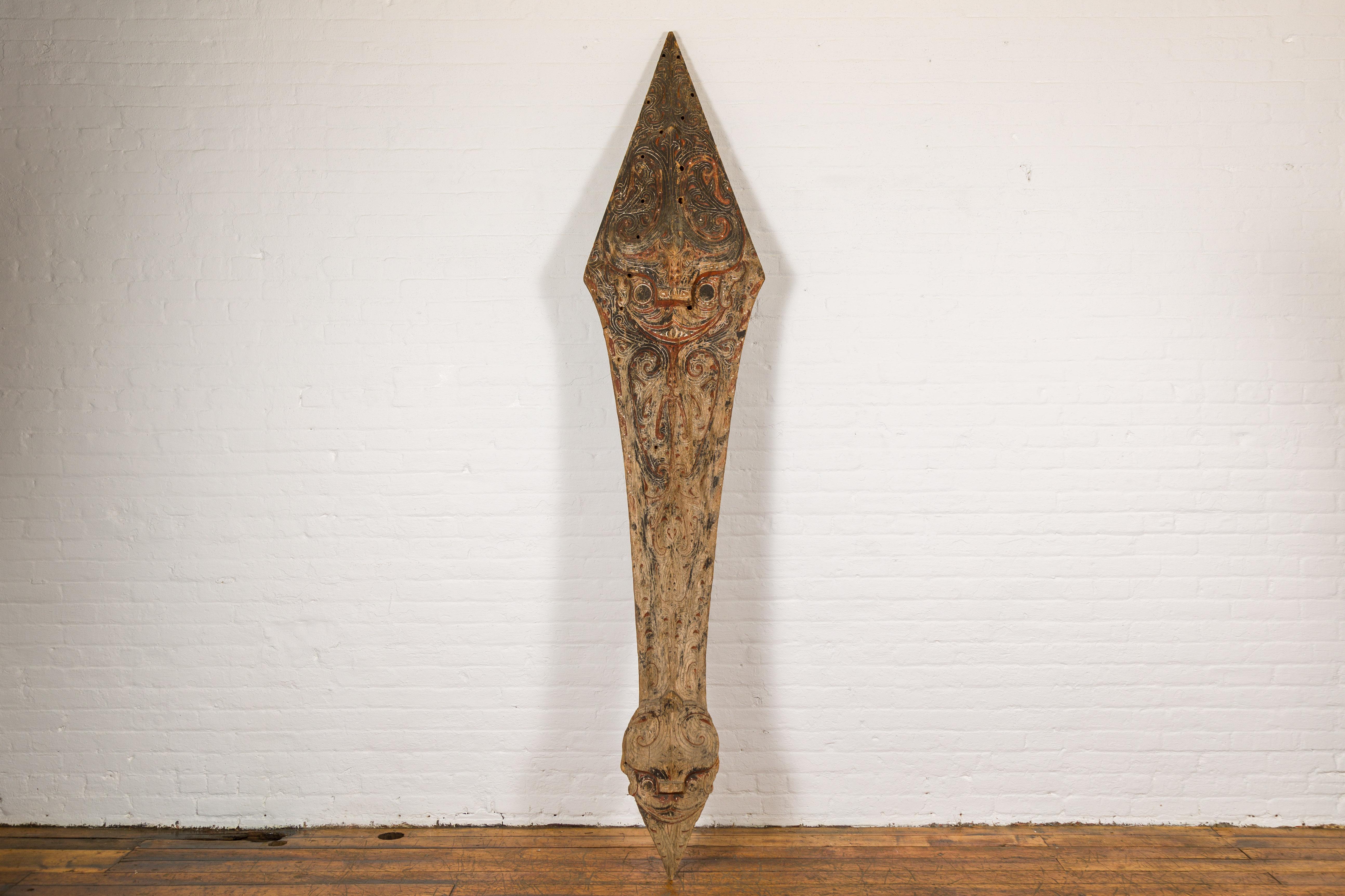 An antique hand carved tribal 19th century sculpture from the Batak People, northern Sumatra, called a Singa Singa. Step into a world of tribal mystique with this striking 19th-century Singa Singa sculpture from the Batak People of northern Sumatra.