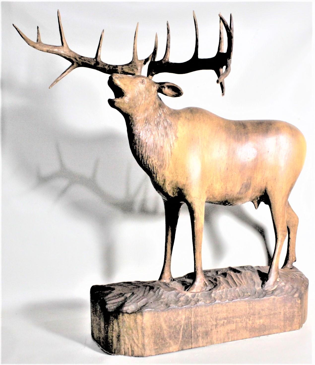 This quite large and well executed carving is unsigned by the artist, but presumed to have been done in Eastern Europe in circa 1900 in the period Black Forest style. This large carving depicts as standing stag deer with a large rack of antlers. The