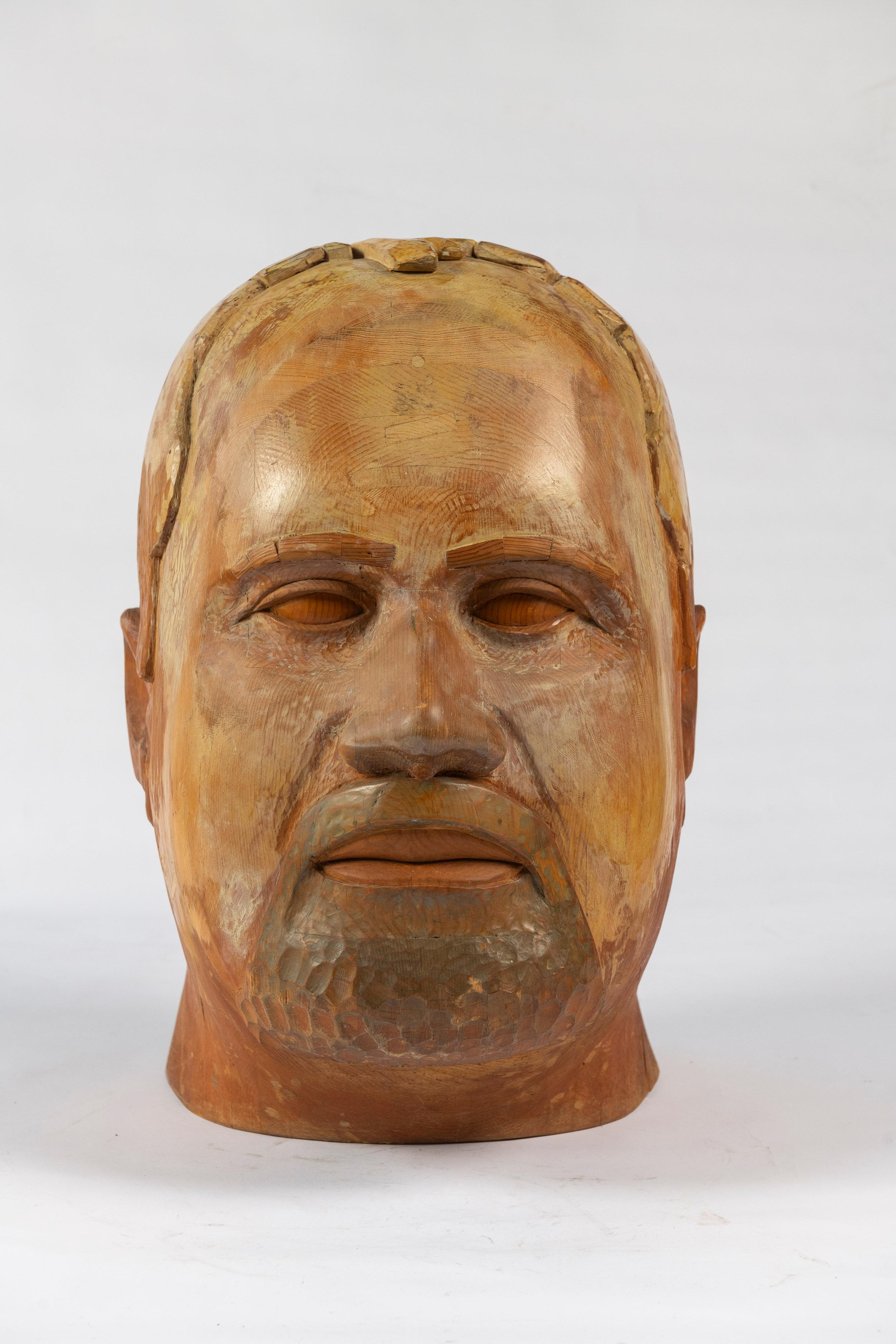Fascinating, Large Scale carved wooden sculpture of a bearded man's head, signed by D. Granahan, 1967, has some painted features and a beautiful patina. The sculpture is a compelling art work, adding texture and interest to a room. Large enough to