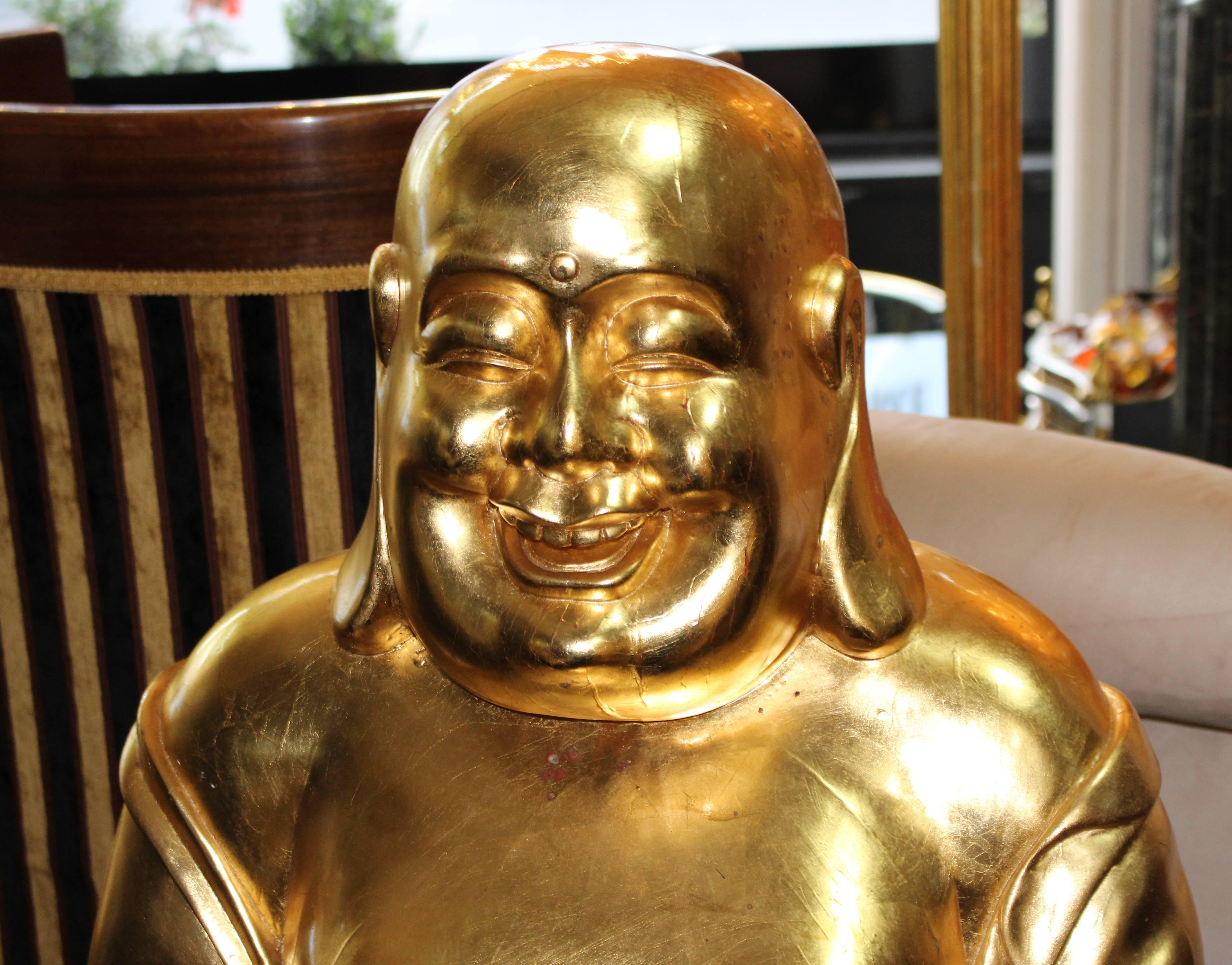 Composition 
wood, hand carved finish 22-carat gold finish. 
Condition: Good condition. Crack to body as pictured. Some marks to gold leaf. N.B. 

Very heavy. 

One of two hand carved Buddha's we are offering.