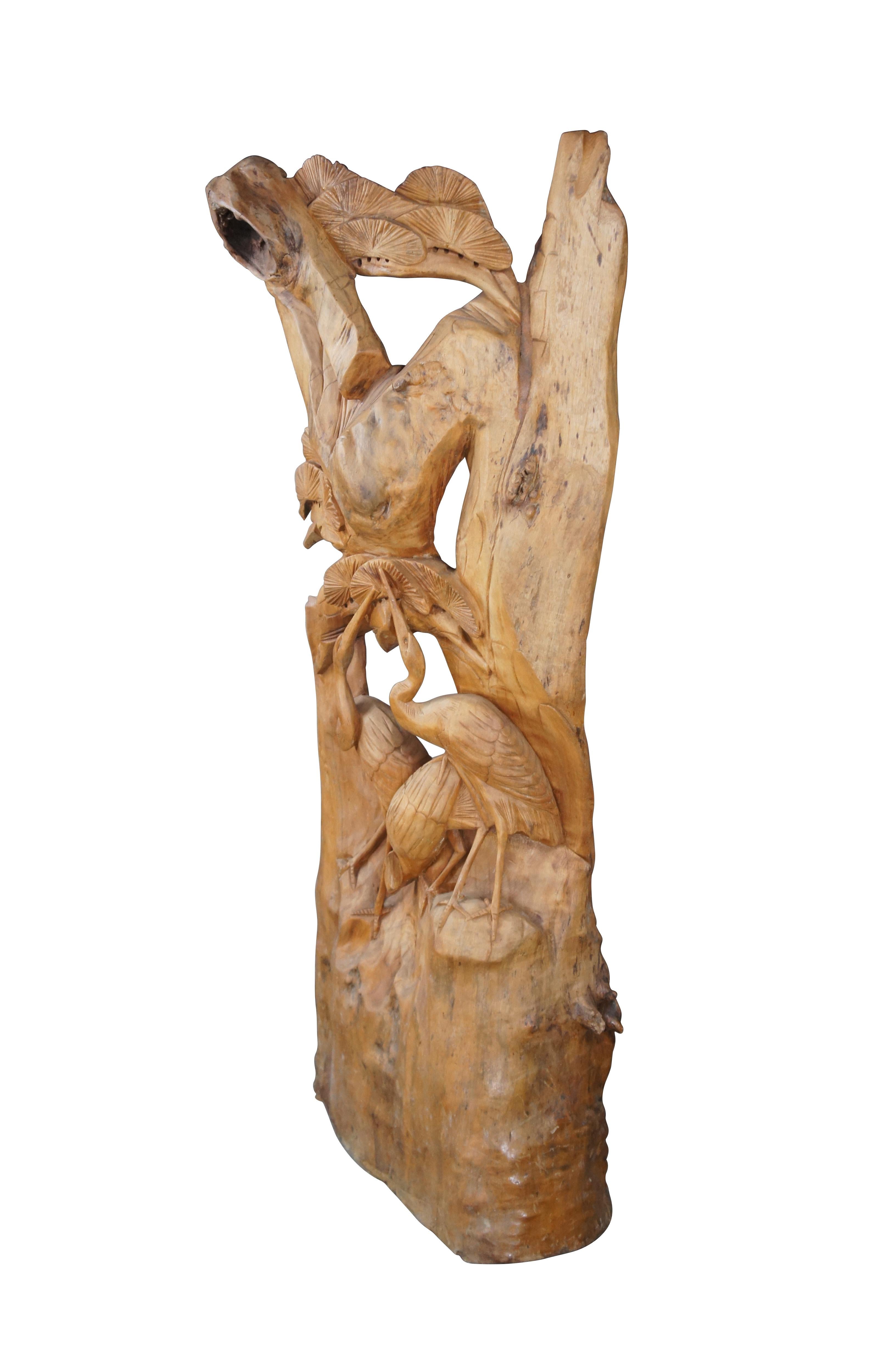Hand Carved heron wildlife scene. The tree features three herons towards the base stretching upwards towards foliate. Beautifully designed with rustic patina     

Dimensions:
61.5