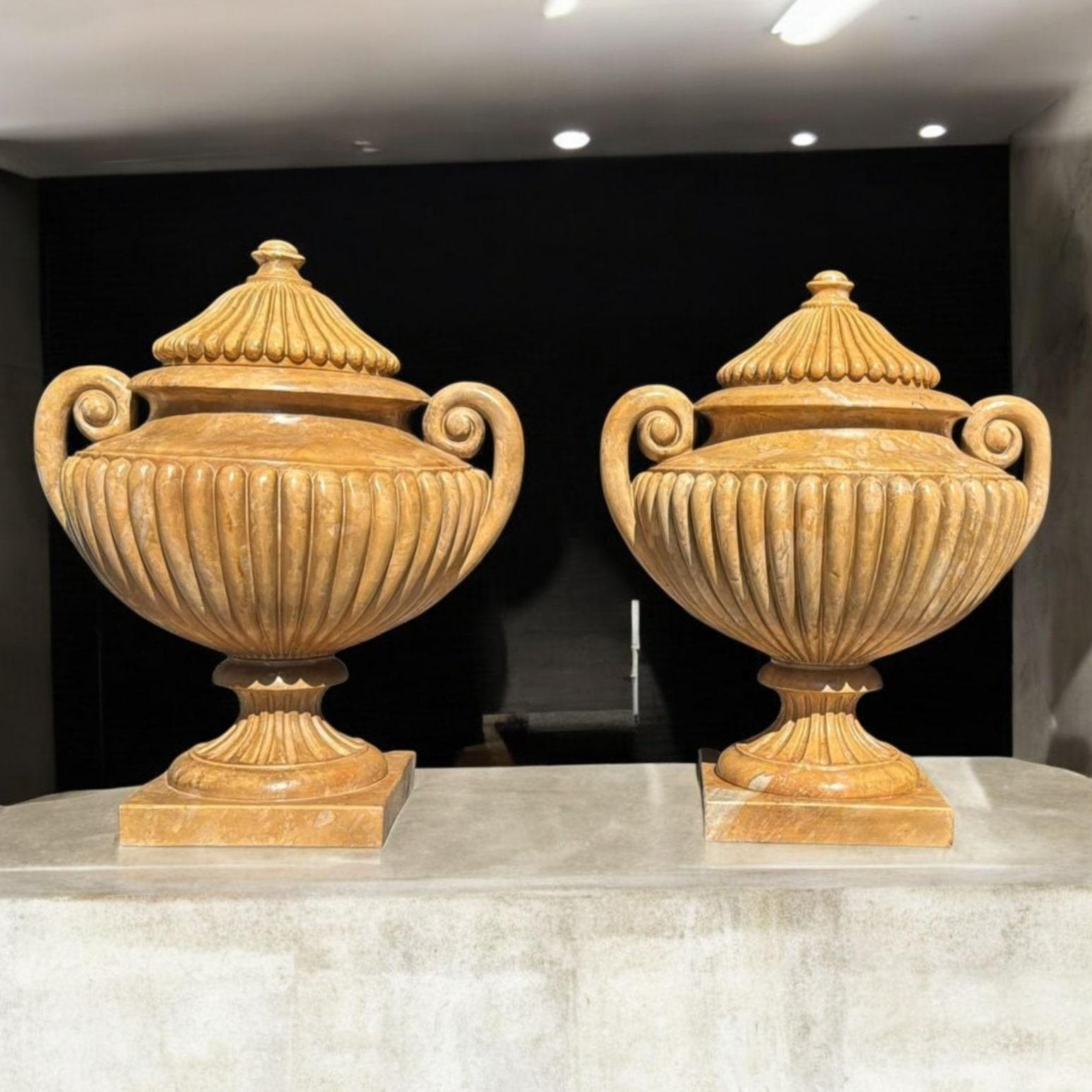 Impressive large urns meticulously hand-carved in Italian marble, dating from the 1950s. These elegant pieces showcase fine craftsmanship with detailed carving and classical proportions.

Origin: Italy

Material: Carved marble

Period: