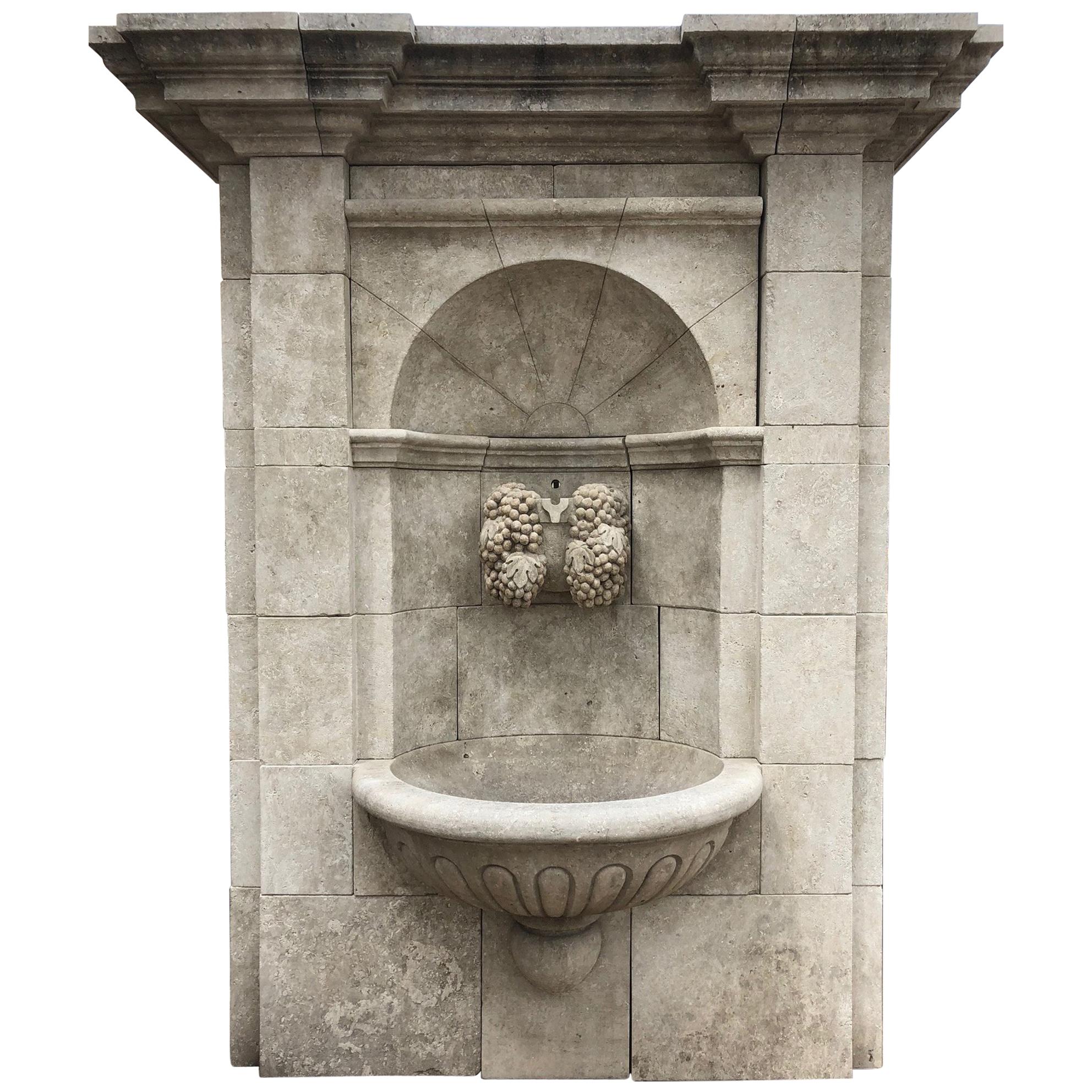 Large Hand-Carved Limestone Wall Fountain from France Featuring Grapevine Spout