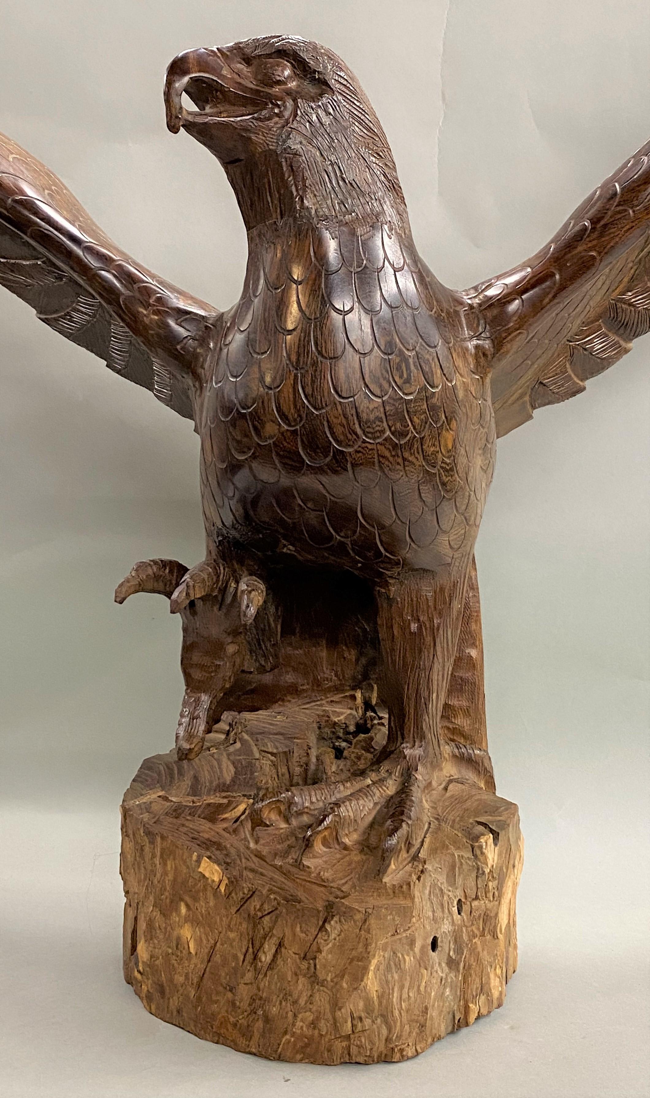 A wonderful folk art hand carved majestic ironwood eagle in the Black Forest style, with full wingspan and one claw extended forward, nice wing and feather detail, unsigned, dating to the 20th century. Very good overall condition, with some edge and