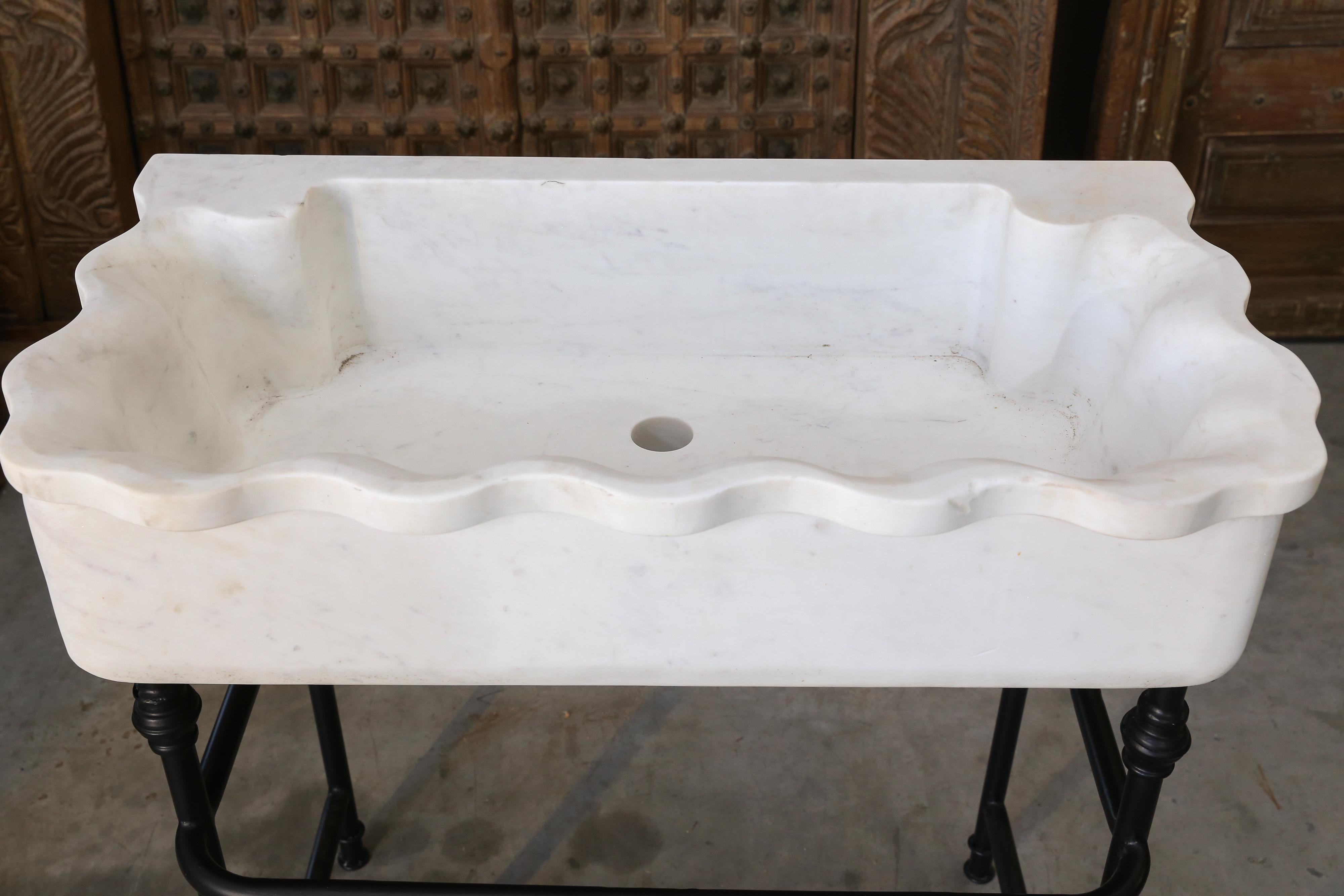 Marble sinks on iron stands were used in the open backyard of colonial homes.
The large marble sink is hand carved from one block of large fine quality marble slab. The support is made of iron and has a towel rack. It is solid and will last several
