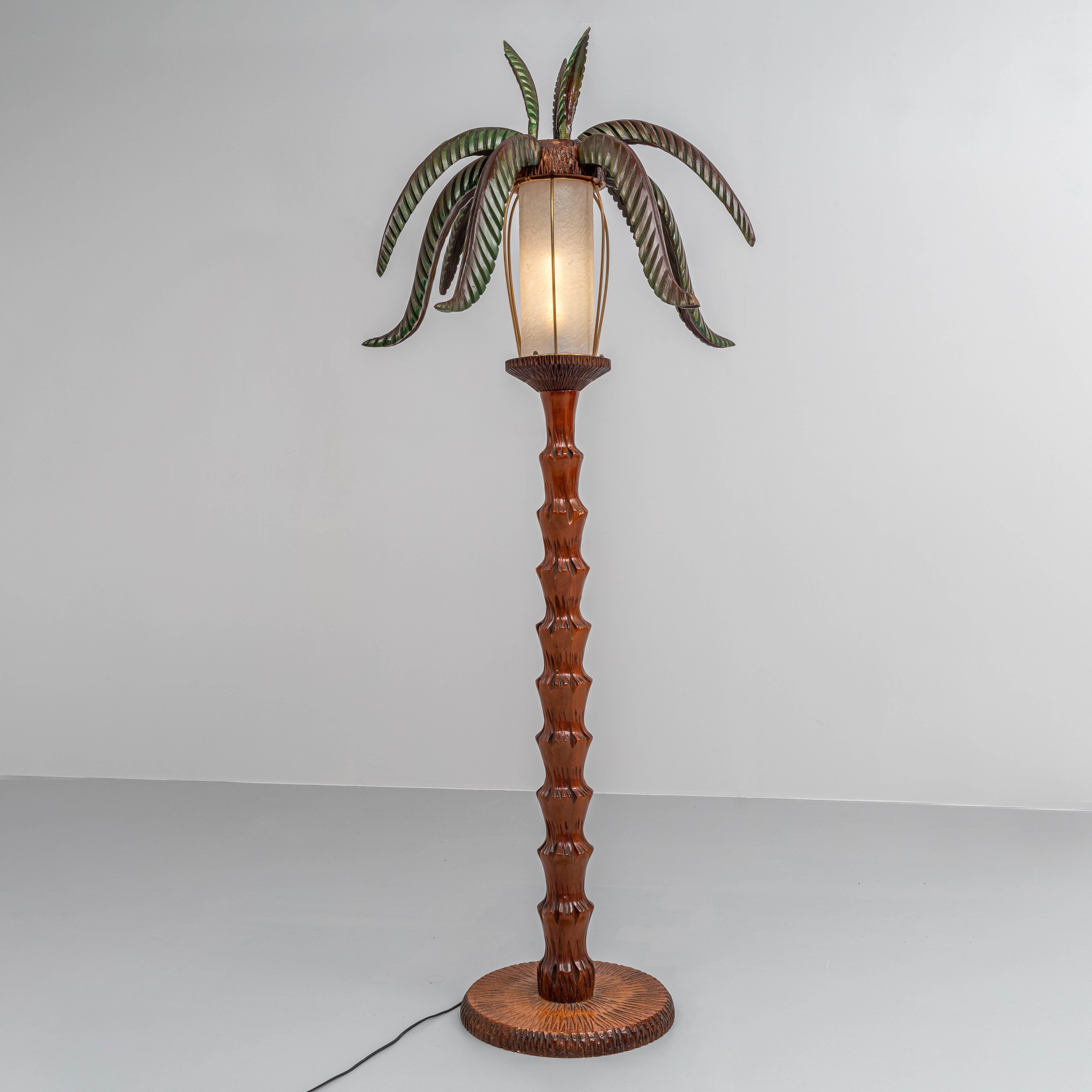 Straight from Naples: a large Palm Lamp model in carved wood and with a lantern made out of skin. Pleasant light and kitch atmosphere are created by the elegantly shaped leaves that curve beautifully in different directions and the carved wood, that