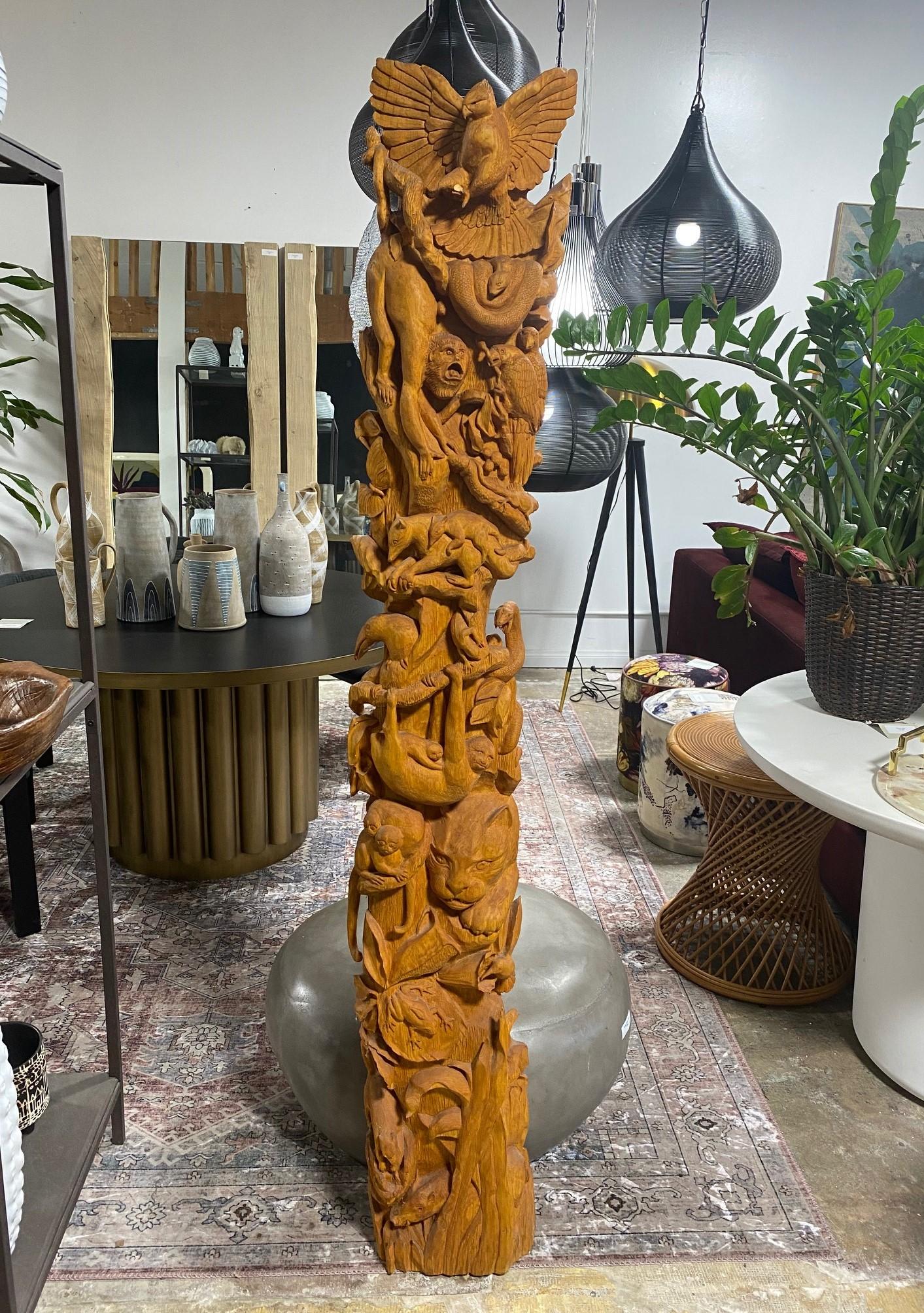 A rather special and intricately carved large, heavy TOTEM sculpture/ pole featuring a wide range of wild jungle animals - birds, snakes, wild boar, frogs, monkeys, lions, reptiles, etc. We have not seen another quite like it. Perhaps Native