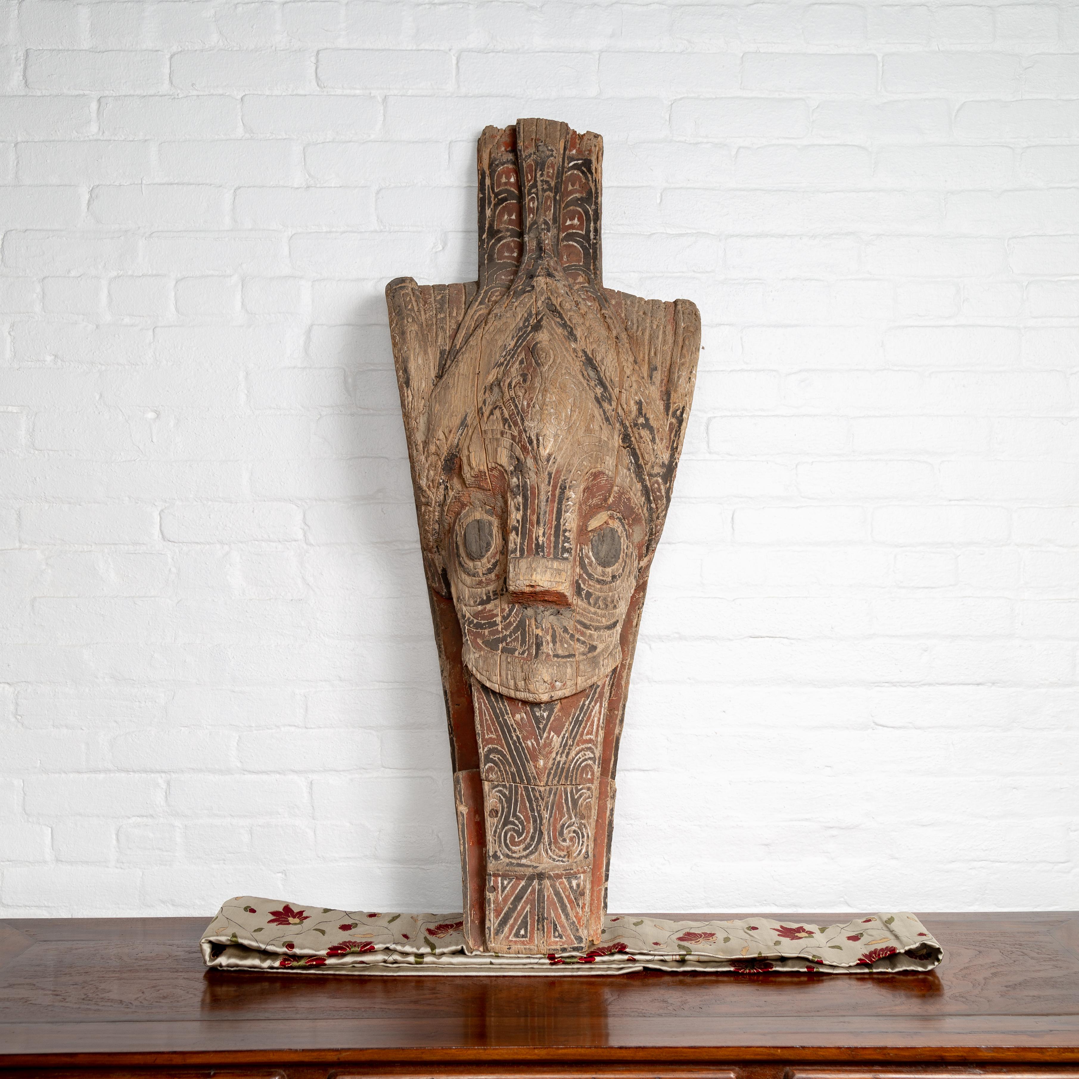 A large antique hand carved tribal carving from the Batak people, northern Sumatra, called a Singa Singa. Attracting our eye with its charismatic presence, this large hand carved sculpture from the Indonesian island of Sumatra is one of the most