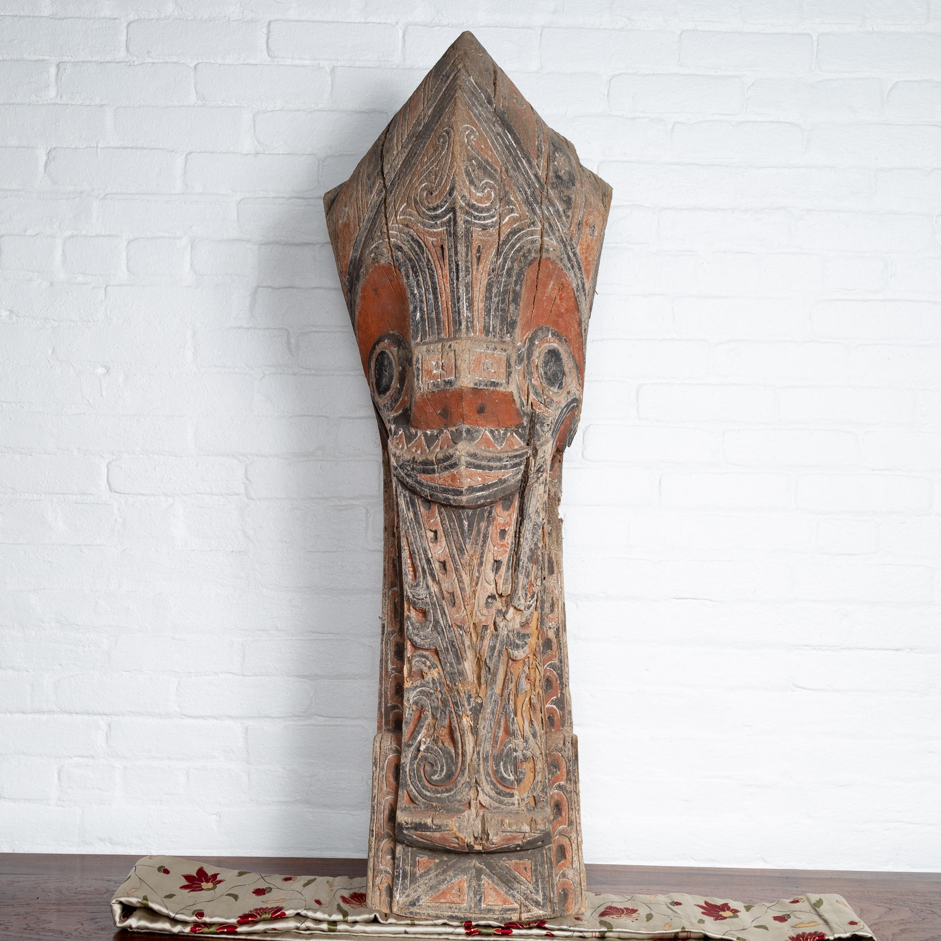 A large antique hand carved tribal carving from the Batak People, northern Sumatra, called a Singa Singa. Attracting our eye with its charismatic presence, this large hand carved sculpture from the Indonesian island of Sumatra is one of the most