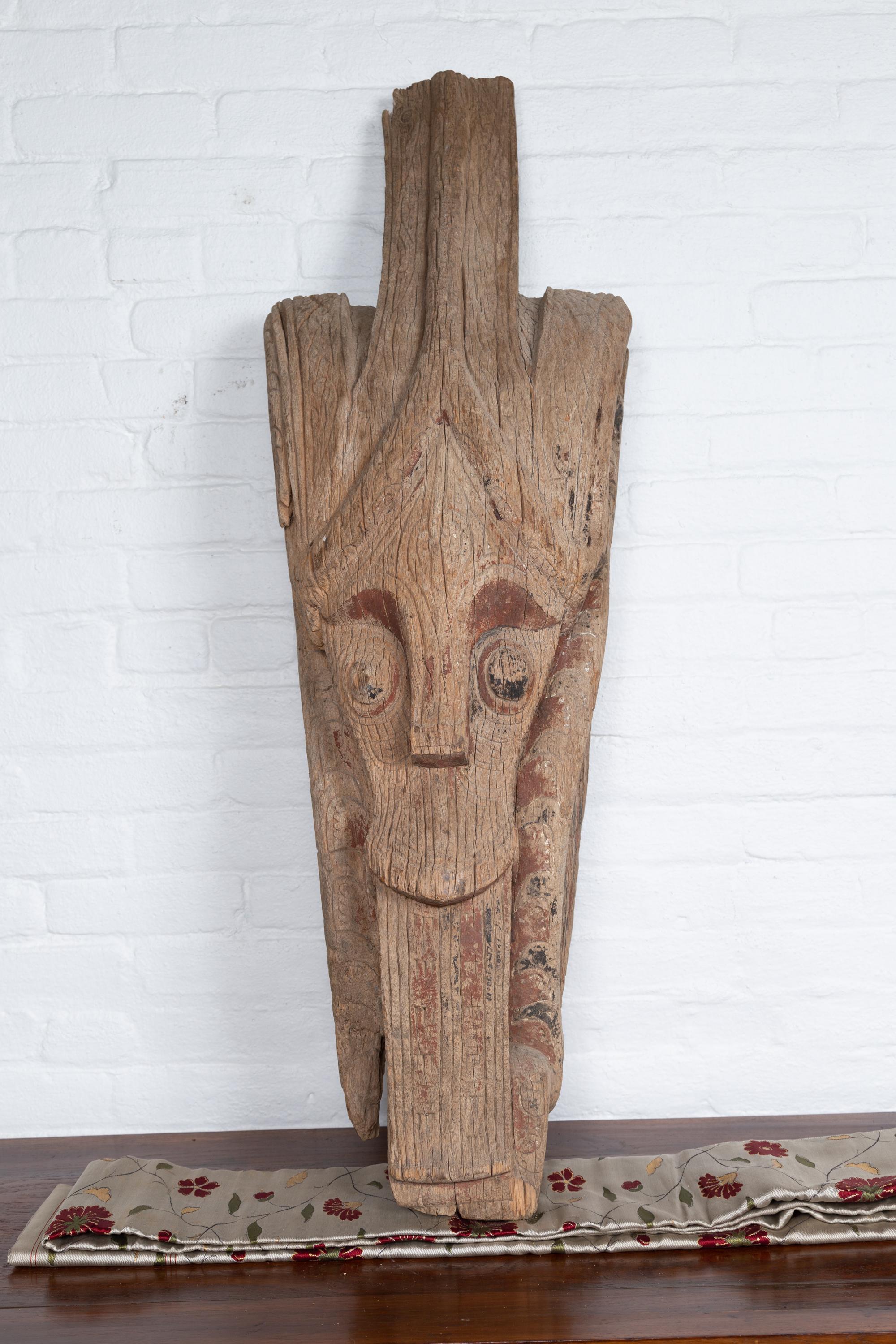 A large antique hand carved tribal sculpture from the Batak People, northern Sumatra, called a Singa Singa. Attracting our eye with its charismatic presence, this large hand carved sculpture from the Indonesian island of Sumatra is one of the most