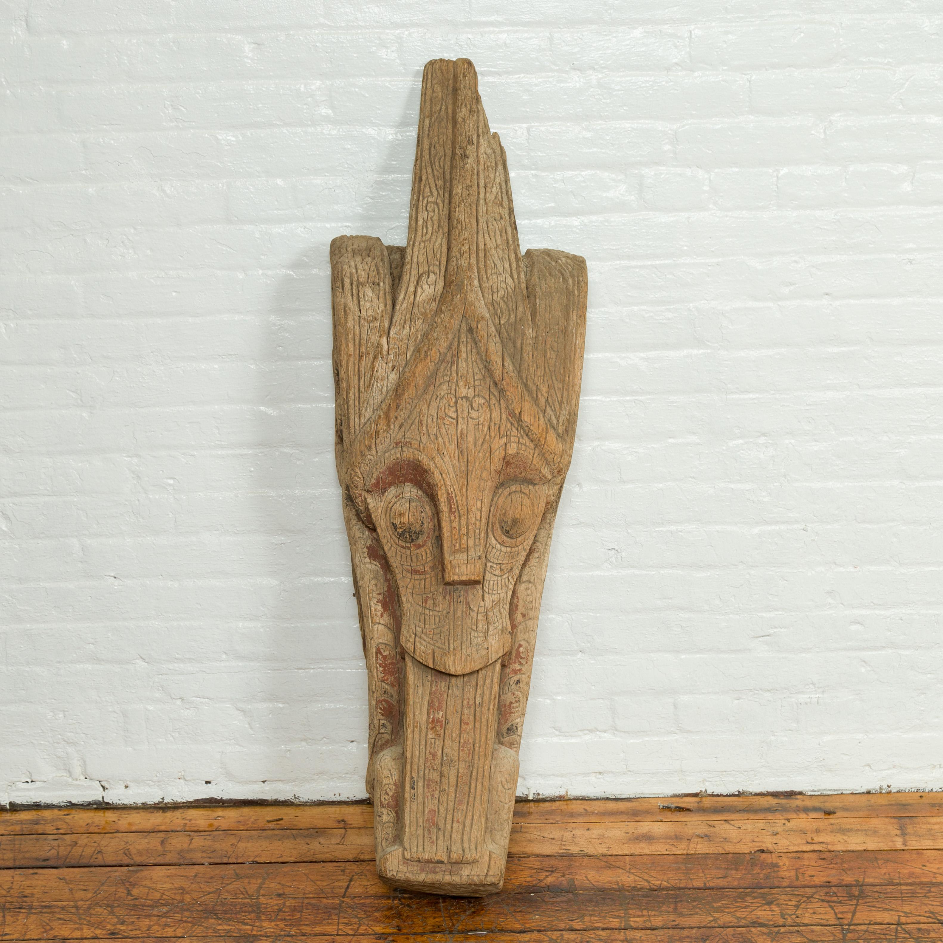A large antique hand carved tribal sculpture from the Batak People, northern Sumatra, called a Singa Singa. Behold the striking allure of this large antique hand-carved Singa Singa, a tribal sculpture originating from the Batak People of Northern