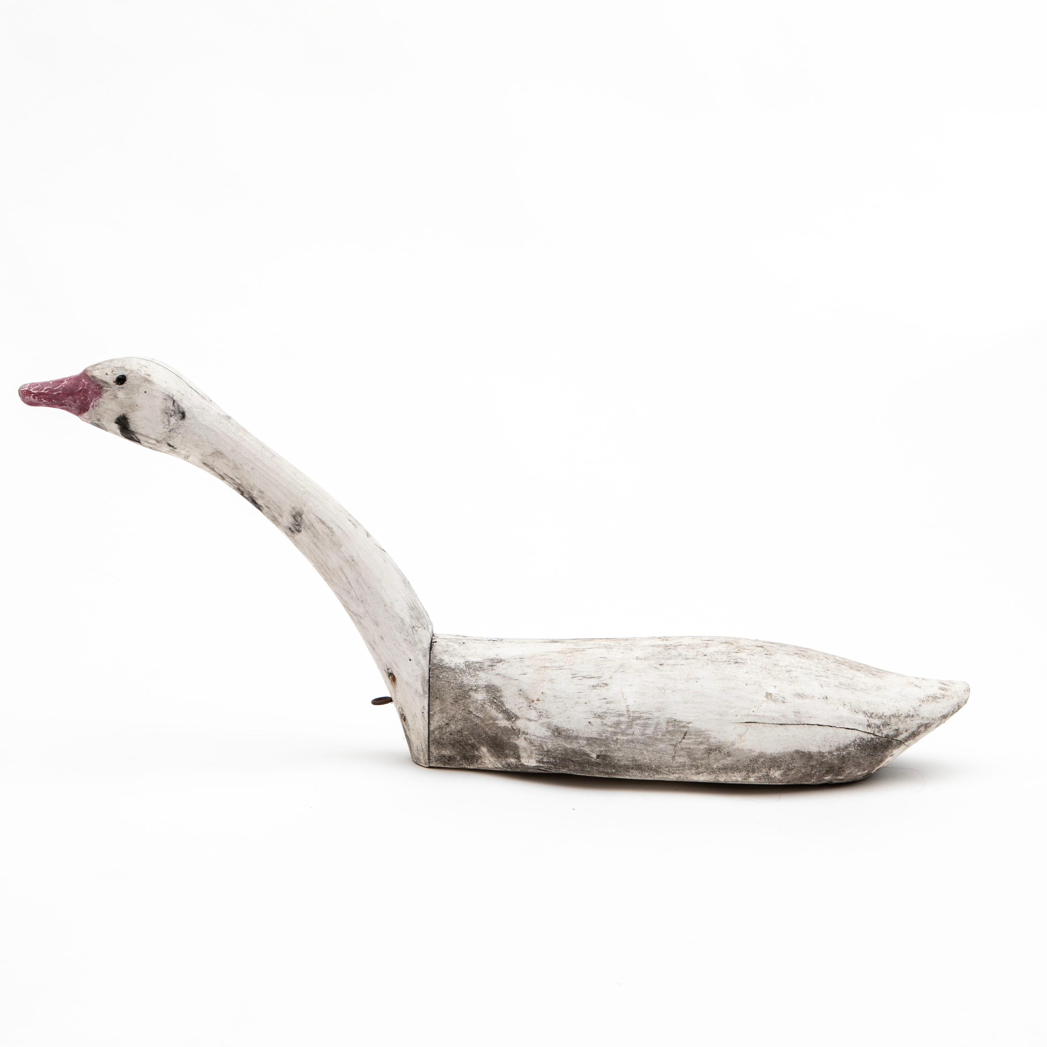 A full size hand carved and painted wooden swan decoy. 
Original paint, white body and reddish beak, glass eyes. In original condition having a wonderful aged patina.
Denmark approx. 1920
