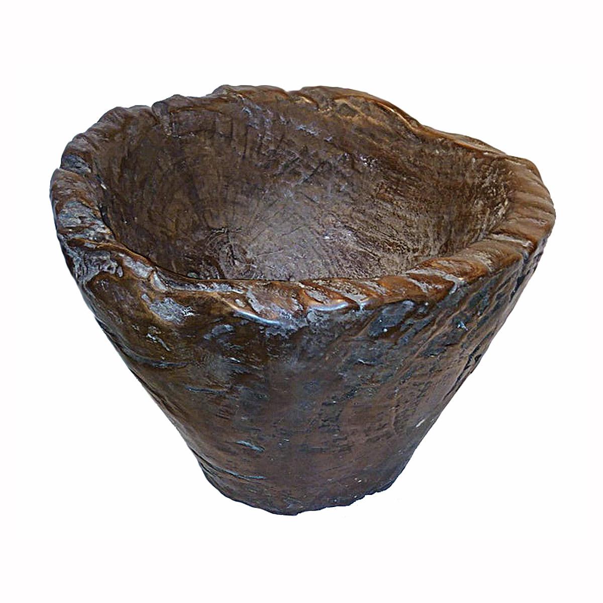 A large teak wood bowl from Indonesia in a dark finish. Hand-carved from a single piece of solid wood, the natural shapes and forms of the wood have been preserved to give this bowl a 