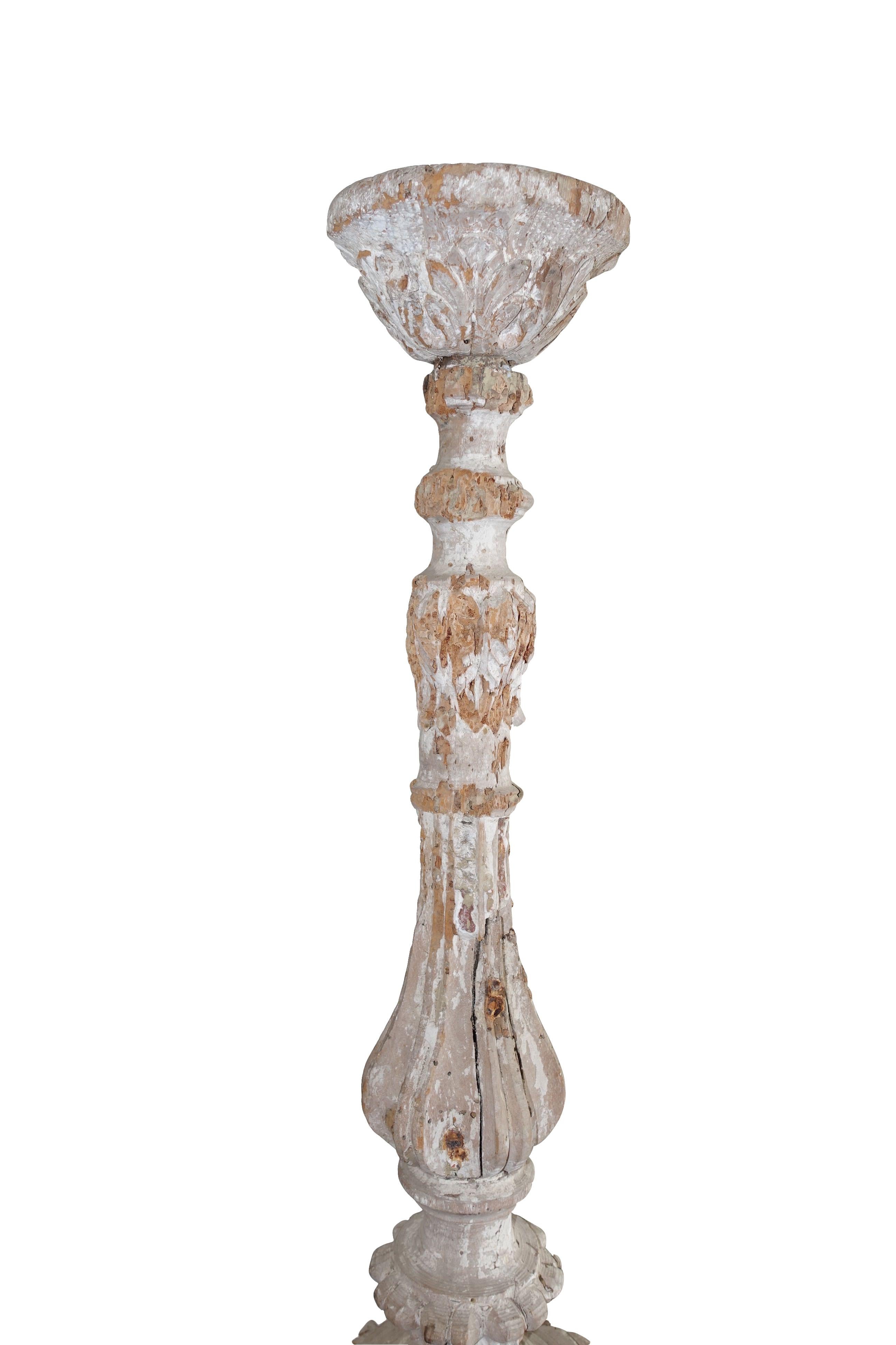 19th century Italian large wooden hand carved candlestick originally housed on alters in cathedrals.
Originally painted white, the candlesticks now have a natural weathered patina. 
Three footed with two facing forward more decorative, as was the