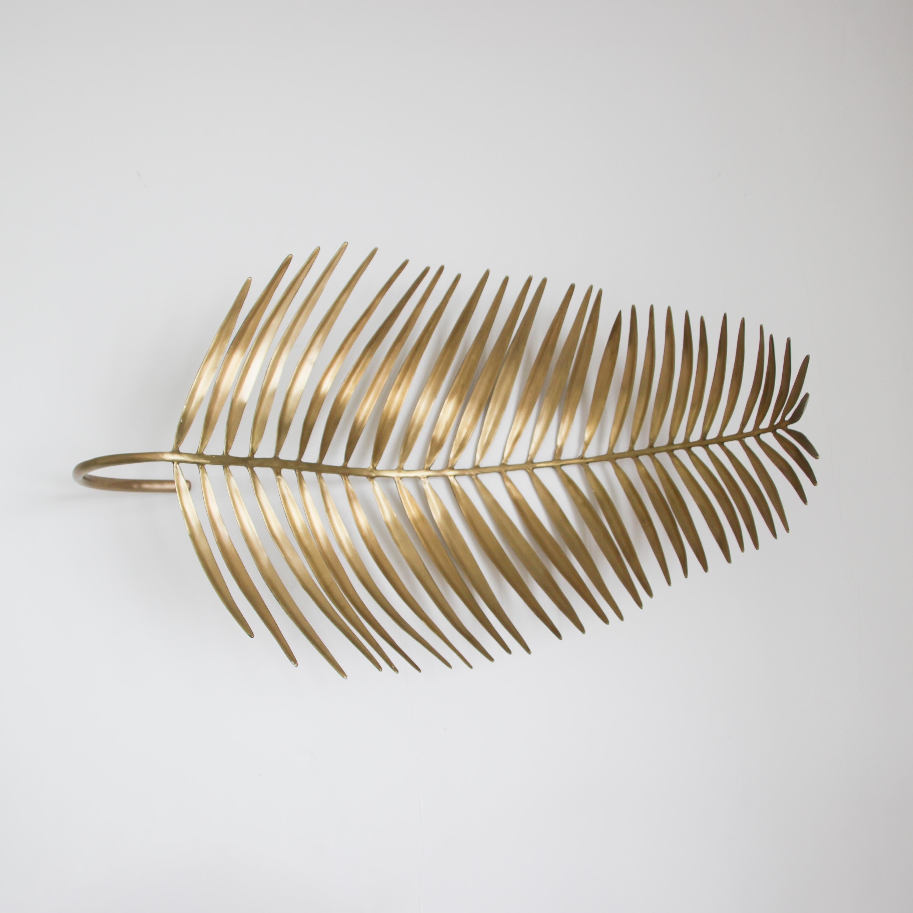 Stunning handmade cast brass palm leaf sculpture with a raw finish.

Dimensions: H 47cm x W 76cm x D 31cm / H 18.5in x W 30in x D 12.2in

Slight variations in the hand-cast brass finishes, patterns and sizes are characteristics of such original