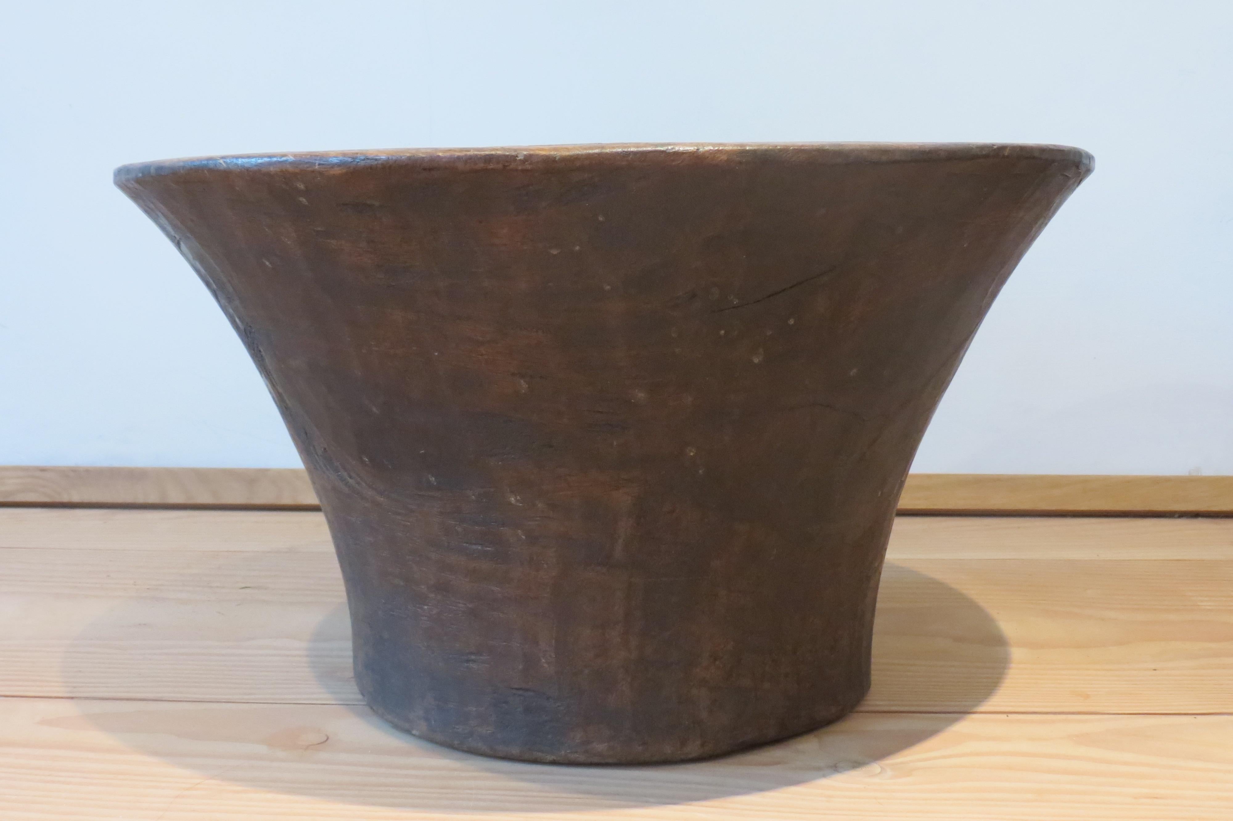 A very large African wooden bowl. Made from African hardwood and dates from the mid 20th Century. The piece has been hand crafted and shaped from a large piece of wood, and it retains signs of the hand shaping allowing the piece to patinate