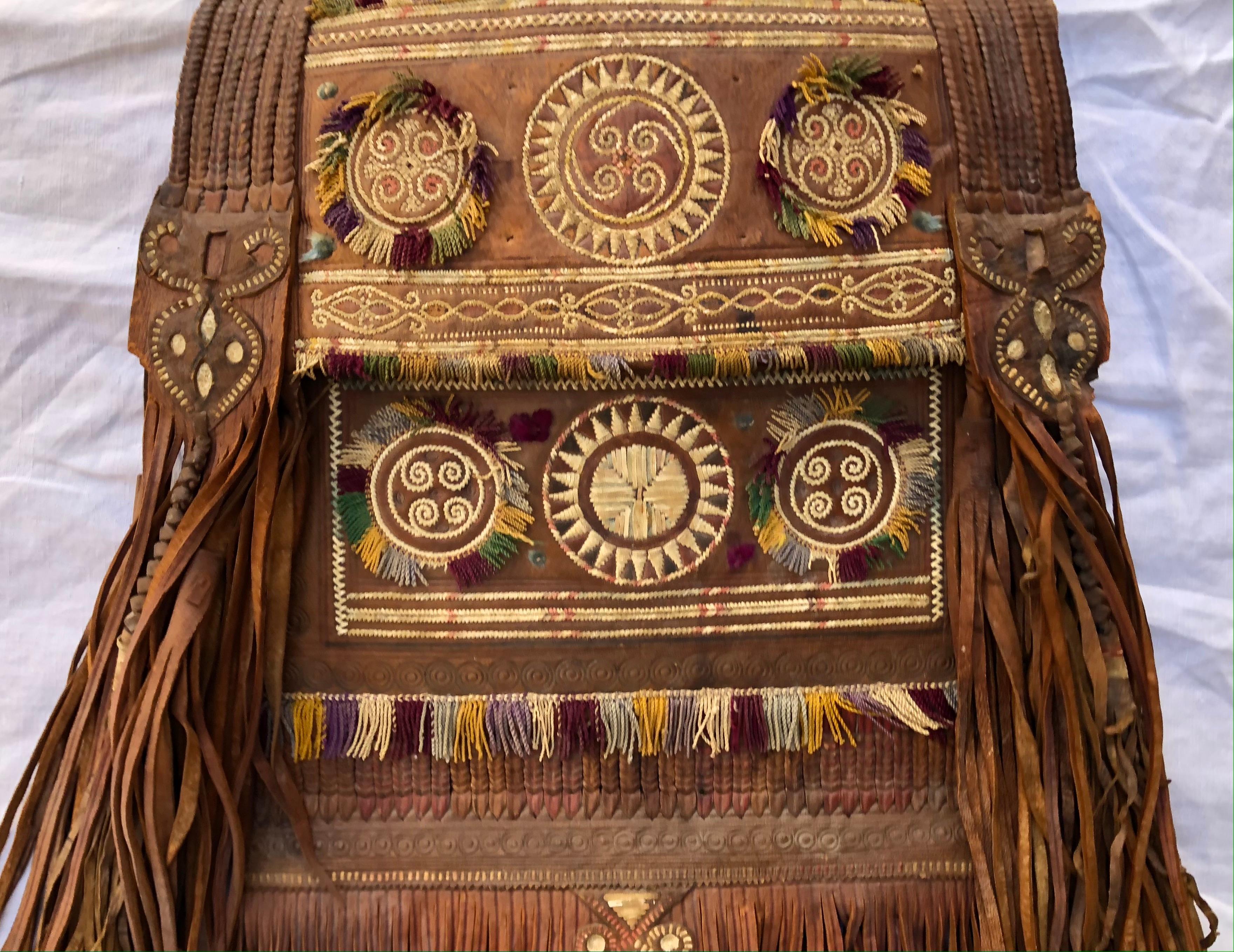 A beautiful antique North African Tuareg Sahara bag. Tribally hand crafted, dyed, embroidered, leather bag with long fringe. The Tuareg are Berber people with a traditionally nomadic pastoralist lifestyle. They are the principal inhabitants of the