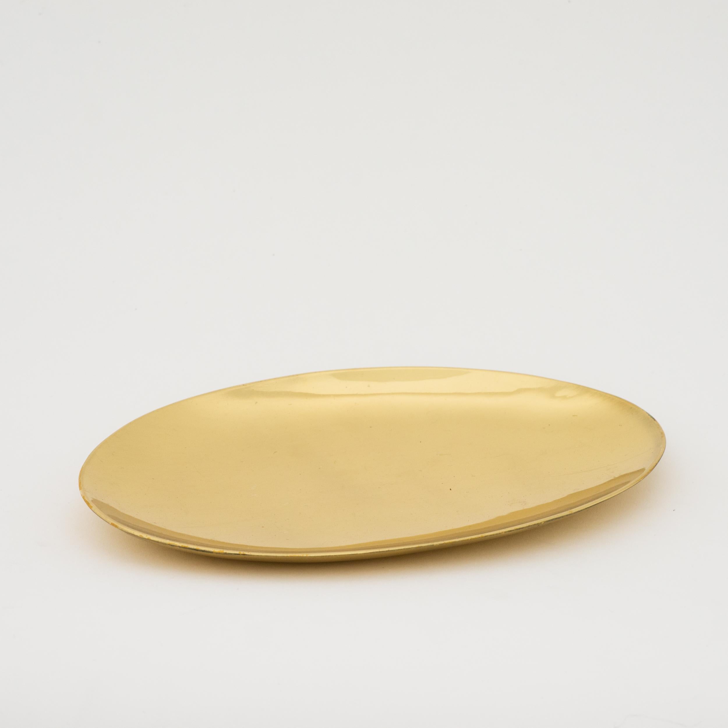 Handmade cast brass plate with a polished finish. Cast using very traditional techniques, it is polished revealing the lustrous finish of this beautiful material.

Slight variations in the patina and polished finishes, patterns and sizes are
