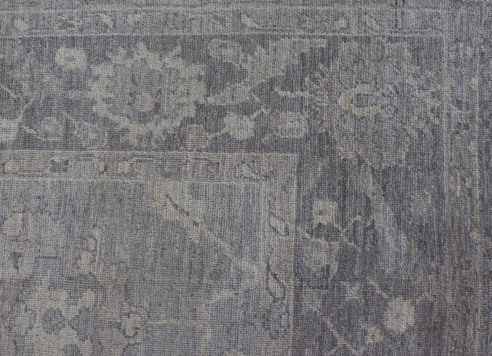Large hand knotted Turkish oushak with floral motifs in grey, taupe & lavender.
Keivan Woven Arts/ rug /AN-146929 Early 21st century.

Made with a combination of angora and old wool, this magnificent vintage Turkish Oushak boasts an all-over