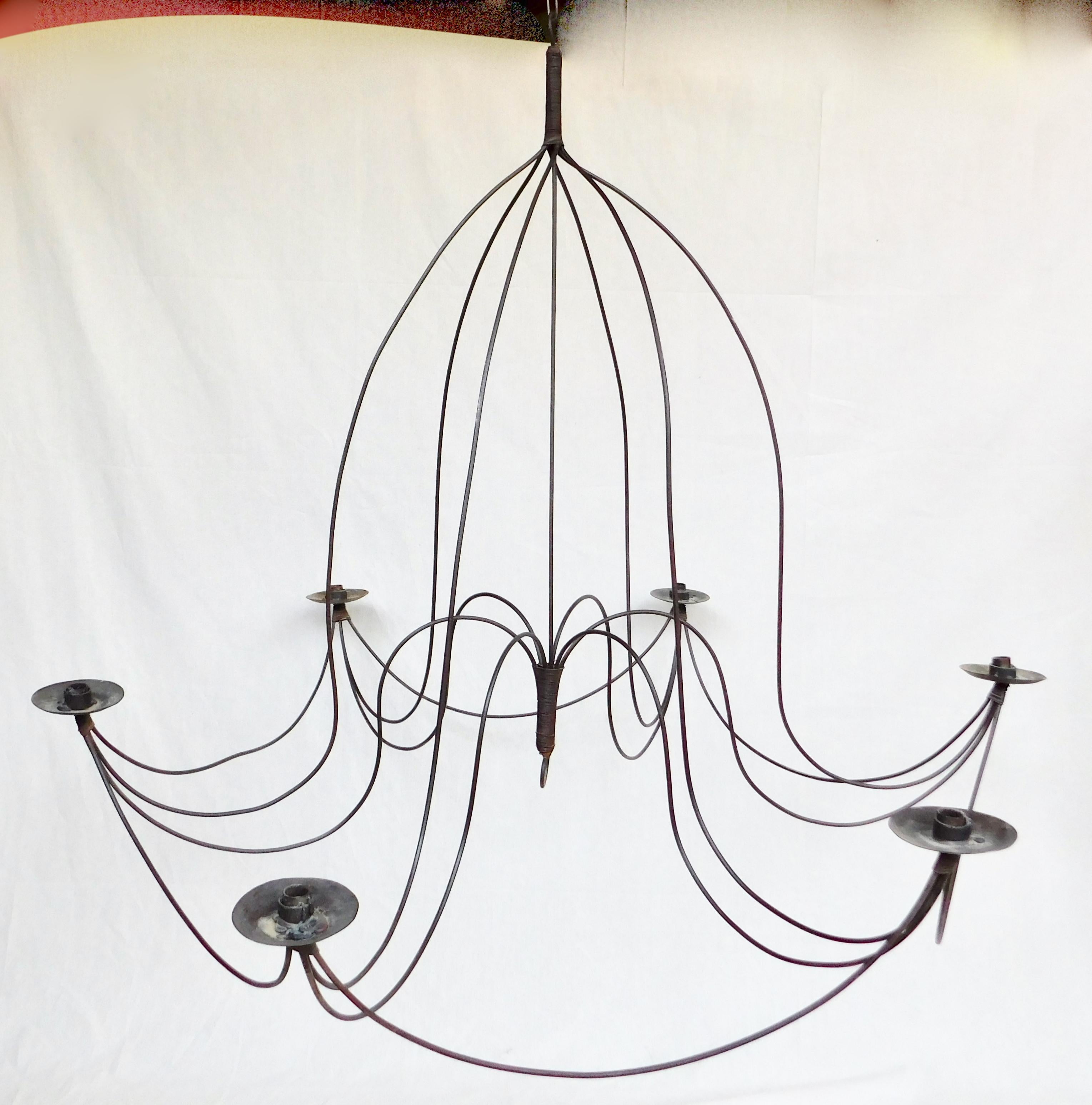 A large handmade vintage Italian metal swag chandelier.
Found in the Italian countryside, this candle chandelier is a large size but light and airy design giving an elegant and delicate feeling not normally associated with metal chandeliers.