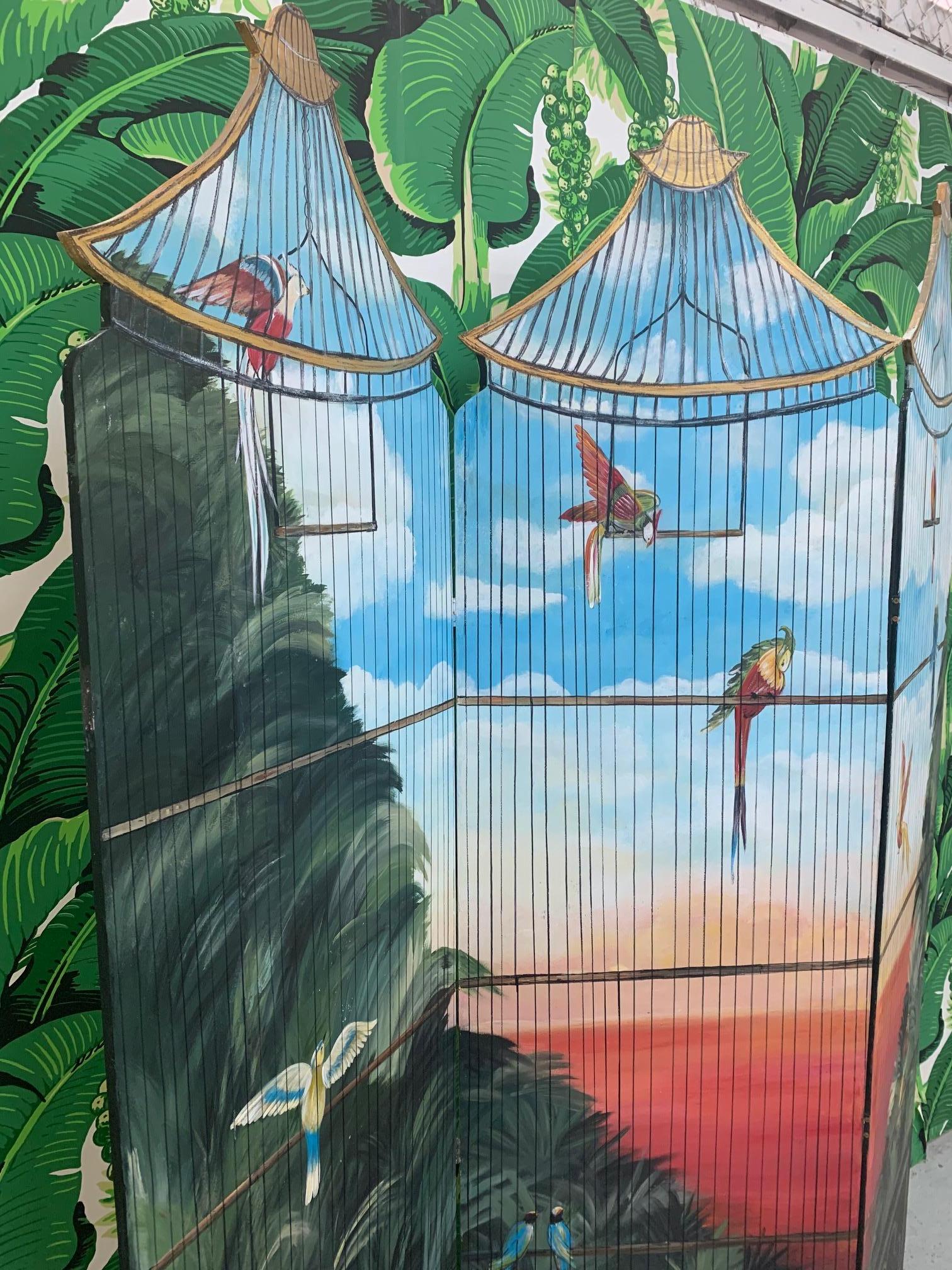 Large 3-panel folding screen features hand painted birdcage scene. Perfect touch of tropical decor for any room. Back of screen is solid white. Good vintage condition with only minor imperfections consistent with age.