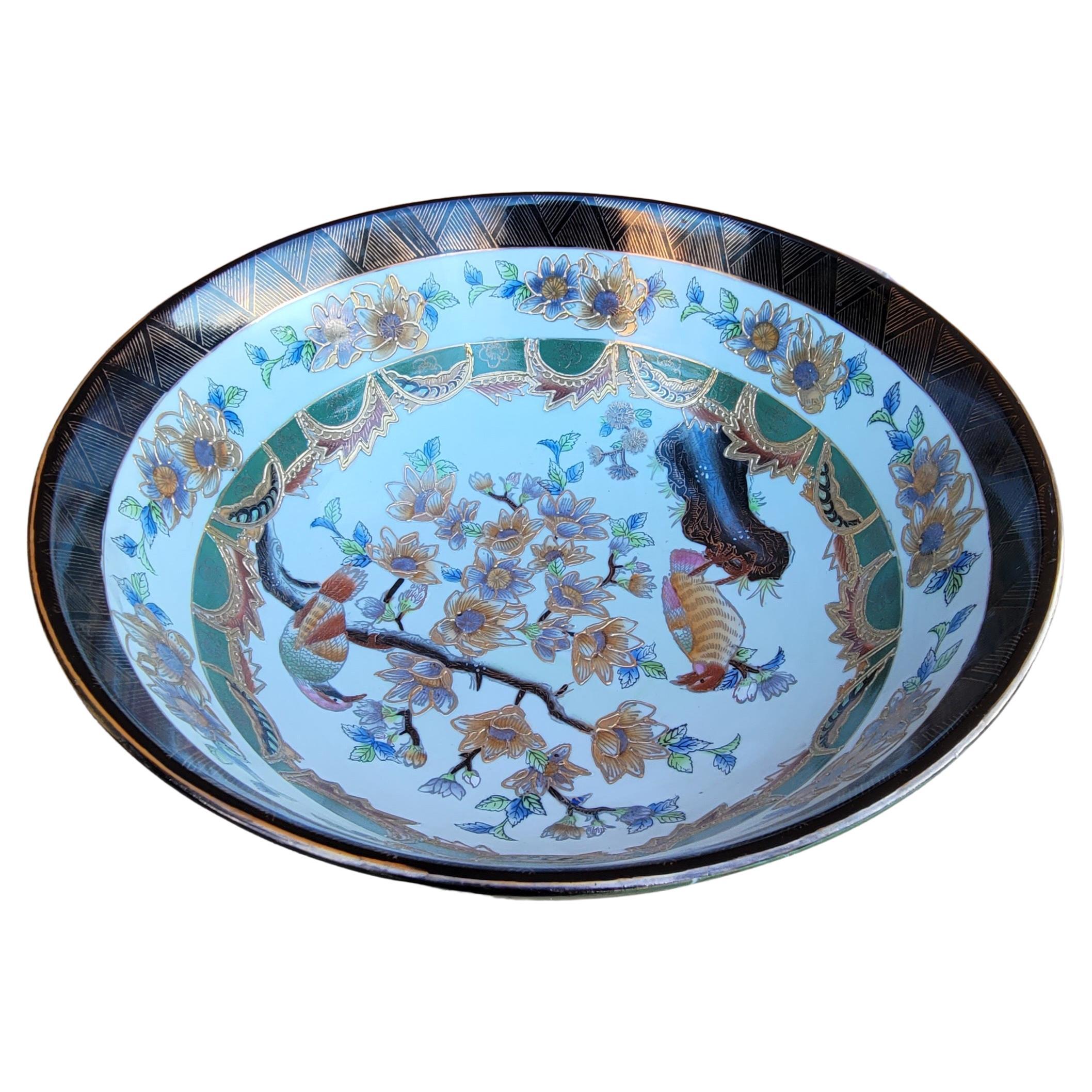 An exquisite large Hand-Painted Chinese Enamel And Gilt Decorated Porcelain Bowl with beautiful flower, birds and branches scenes. Hand-painted and numbered. No cracks or chips. Measures 14