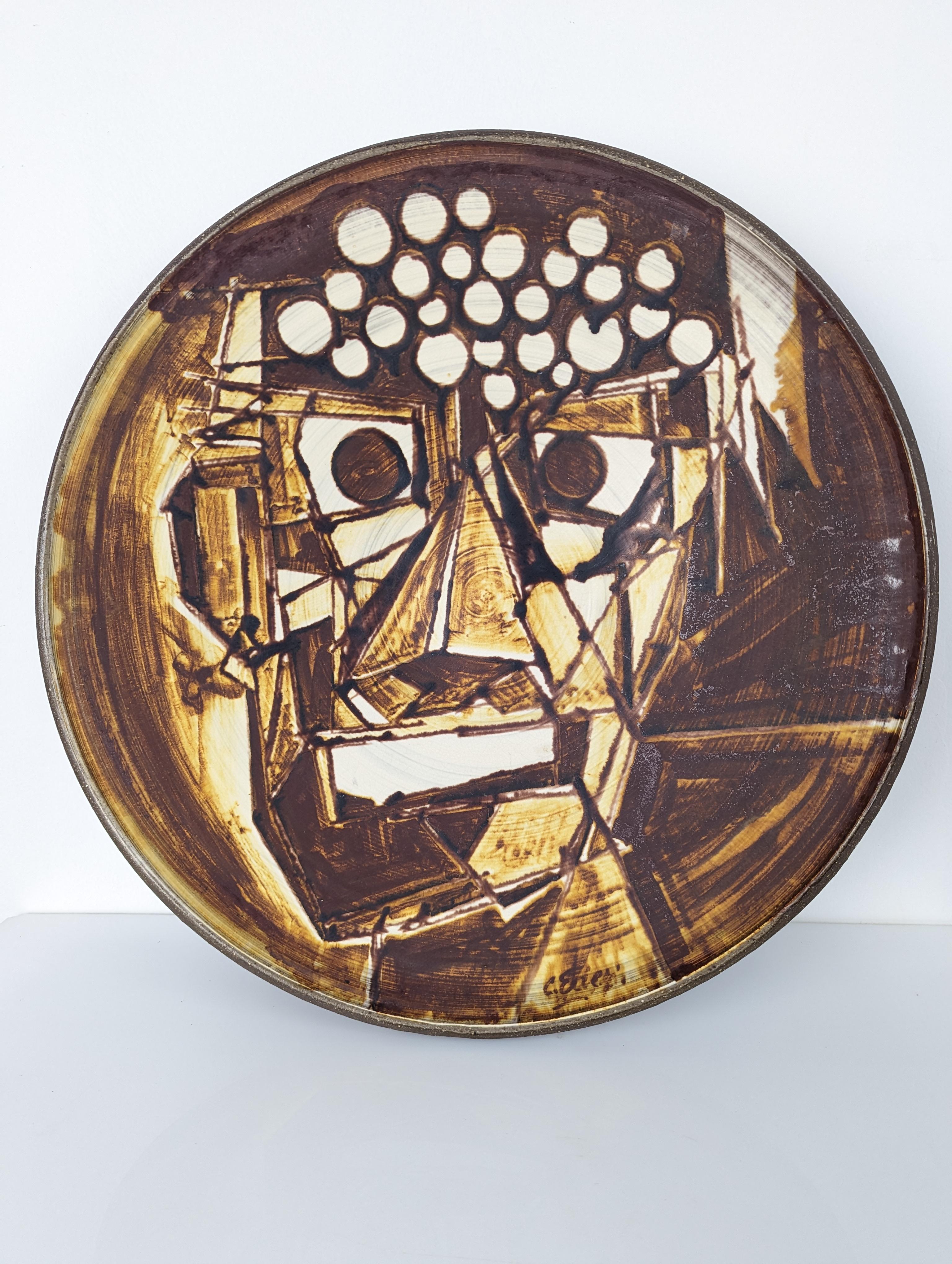 Spectacular large hand-painted plate, showing an incredible portrait with cubist features of great strength and quality, undoubtedly the work of a great mid-century artist yet to be documented. The work is signed on the front and back.