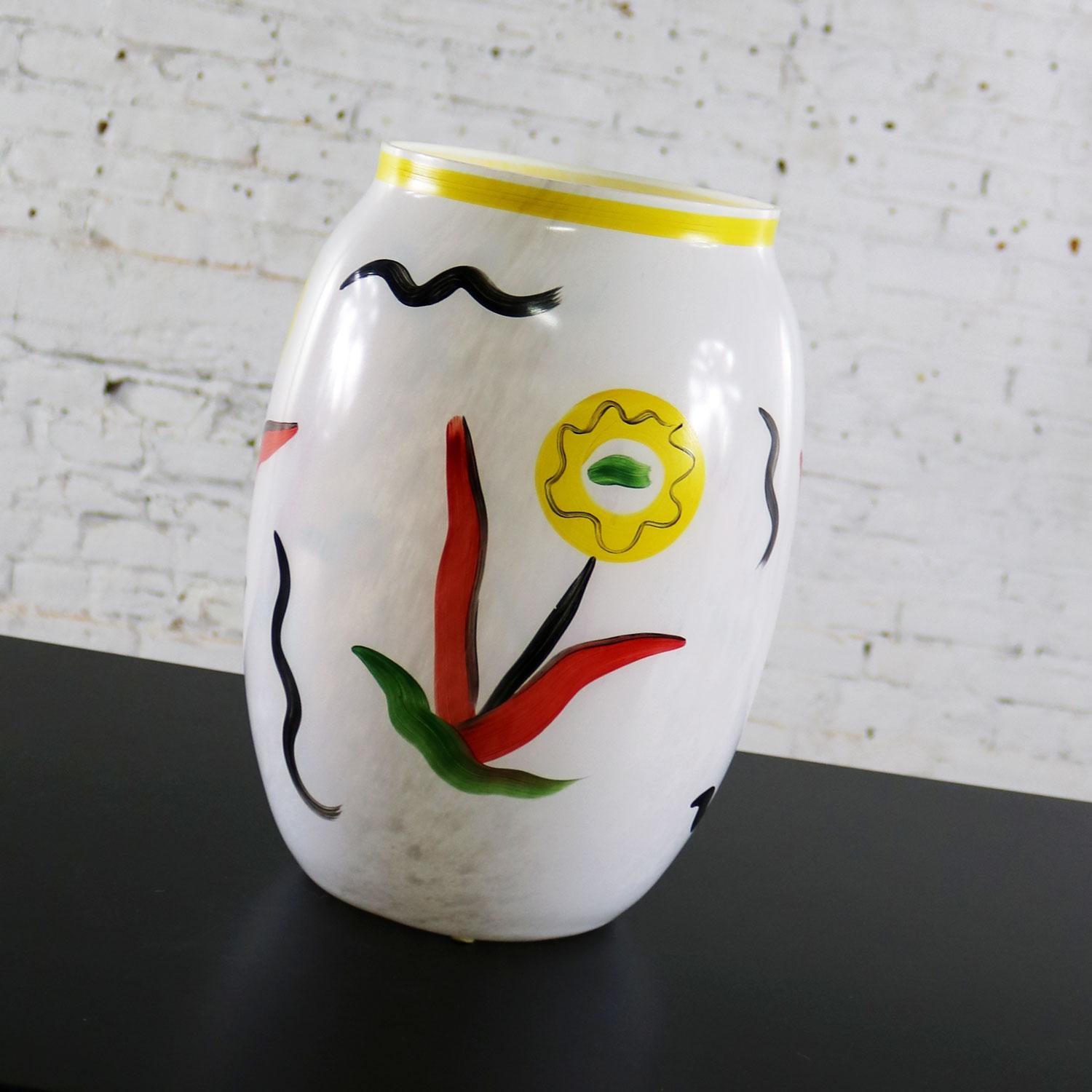 Gorgeous very large hand painted vase depicting impressionistic colorful flowers on a white background by Ulrica Hydman-Vallien for Kosta Boda Atelier. This is a limited-edition vase signed by the artist and numbered 8UHVAT 964001/300. It is in