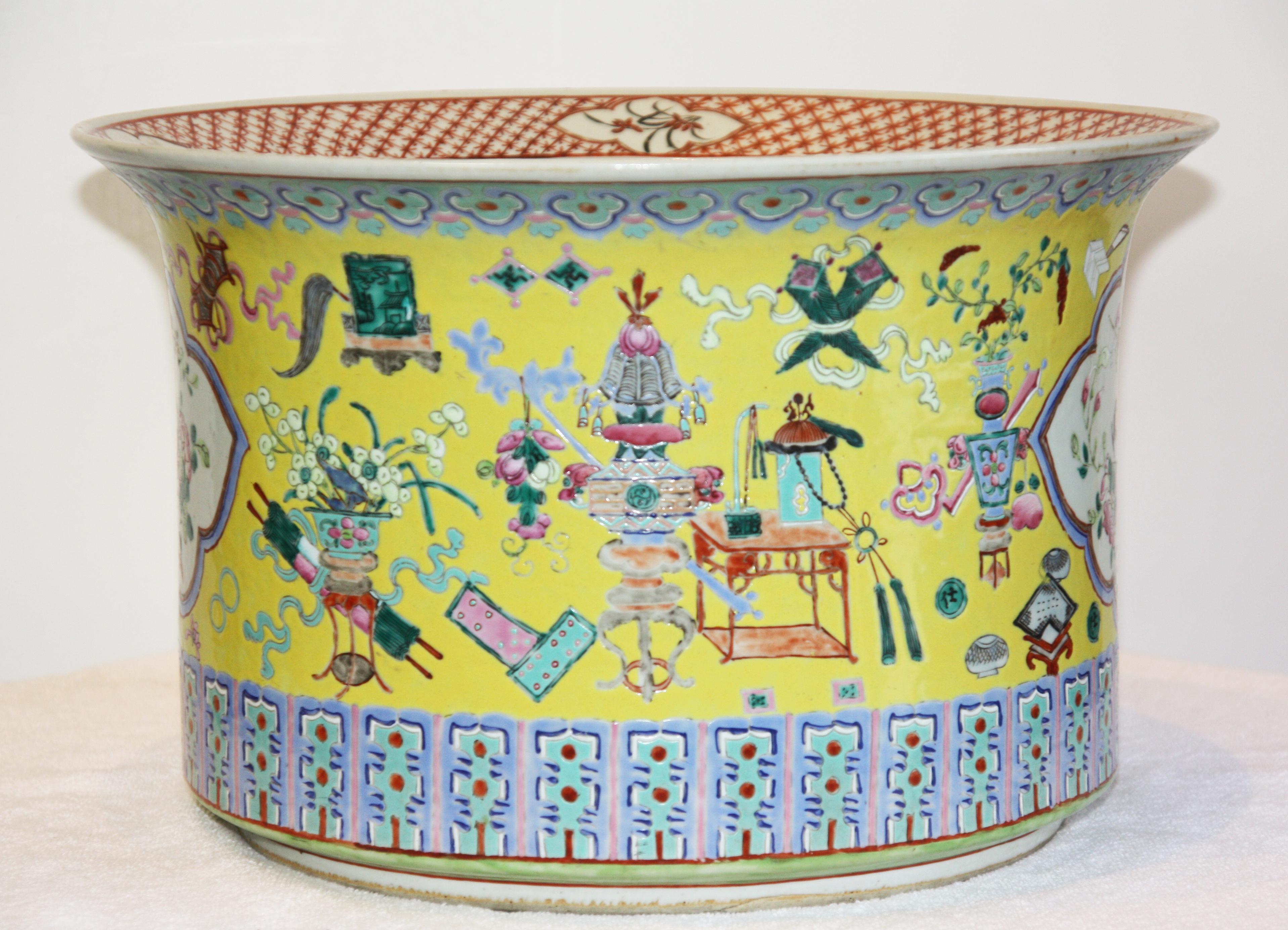 Large, hand-painted yellow jardinière with design band around the top, bird and floral imagery around the centre.