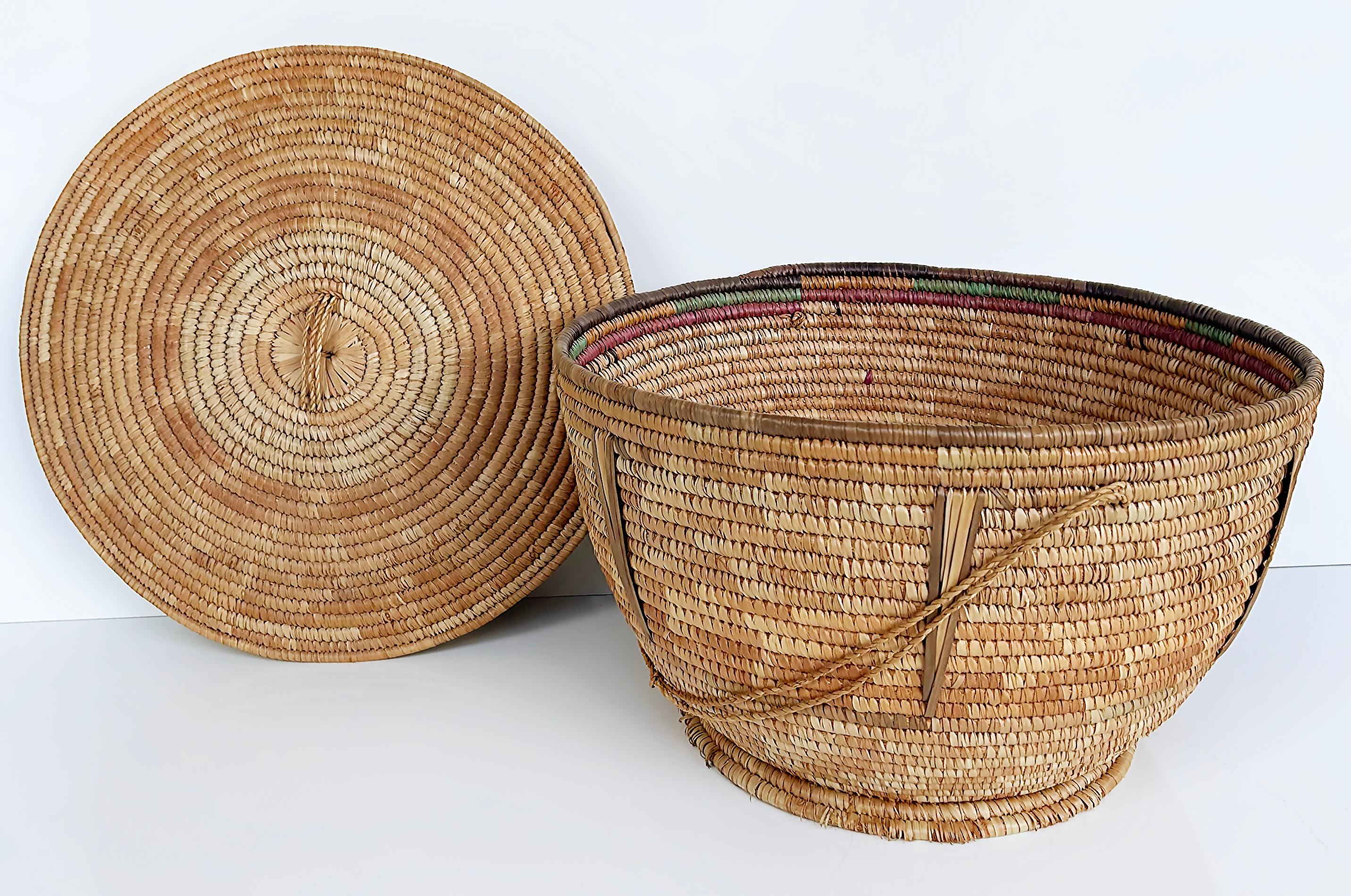 Large Hand-Woven Jute Organic Modern Covered Basket with Rope Handles 

Offered for sale is a large hand-woven jute basket with a rope handle and a woven lid. The base is footed for stability. This attractive basket is very useful for storage yet