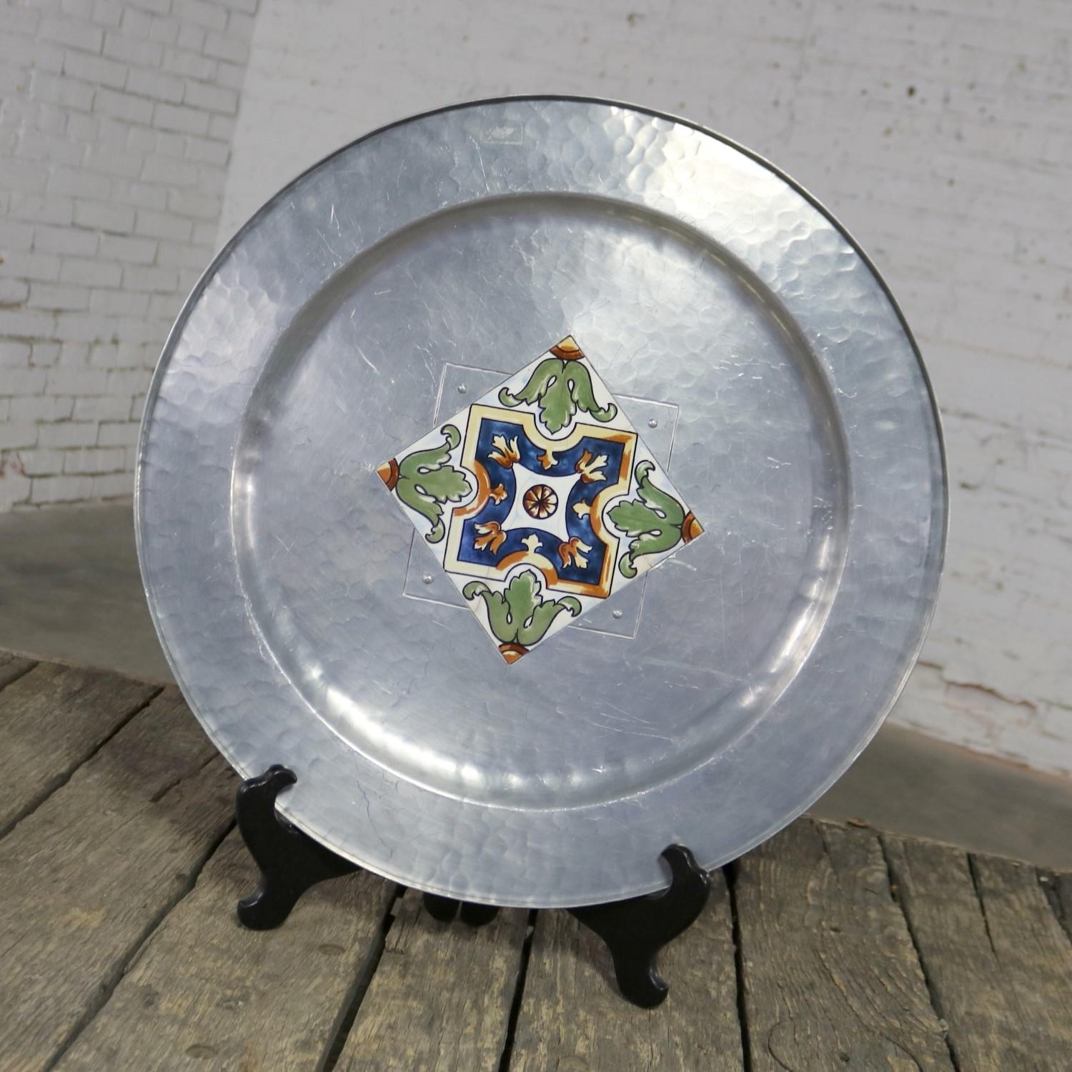 Handsome and large hand-wrought aluminum tray or charger with ceramic tile center signed on back hand-wrought M W Laird Argental. It is in wonderful vintage condition. There are some scratches to the back. But, the front is blemish free as far as we