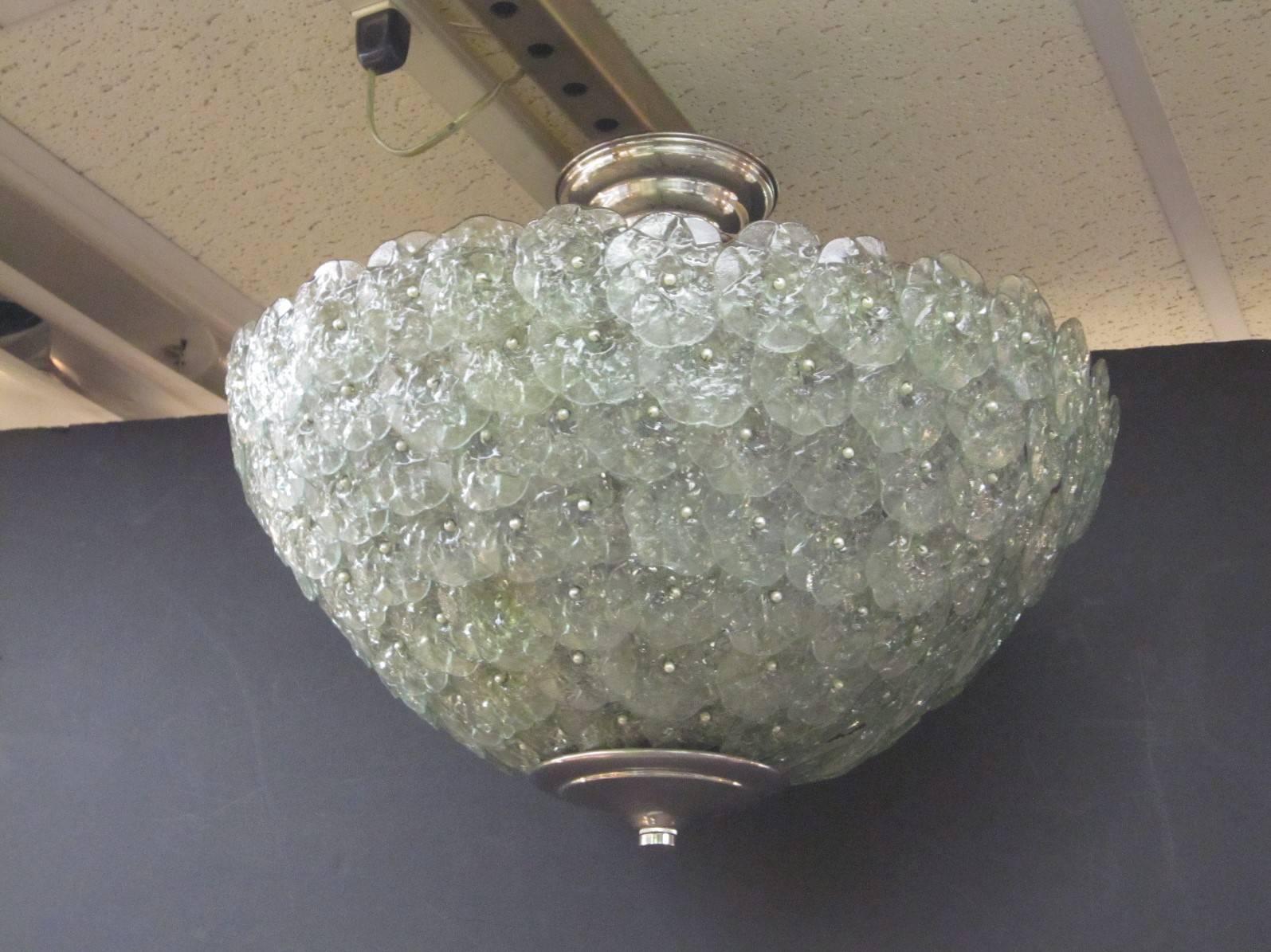 Mid-Century Modern handblown Italian flush mount chandelier featuring overlapping crystal flowers in light emerald green, celadon mounted on a webbed metal frame.
Attributed to Barovier et Toso
We can lengthen or shorten this to any height, even
