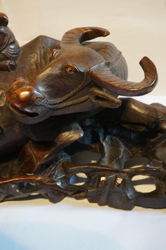 Large handcarved Asian wooden sculpture of a water buffalo with calf and figures