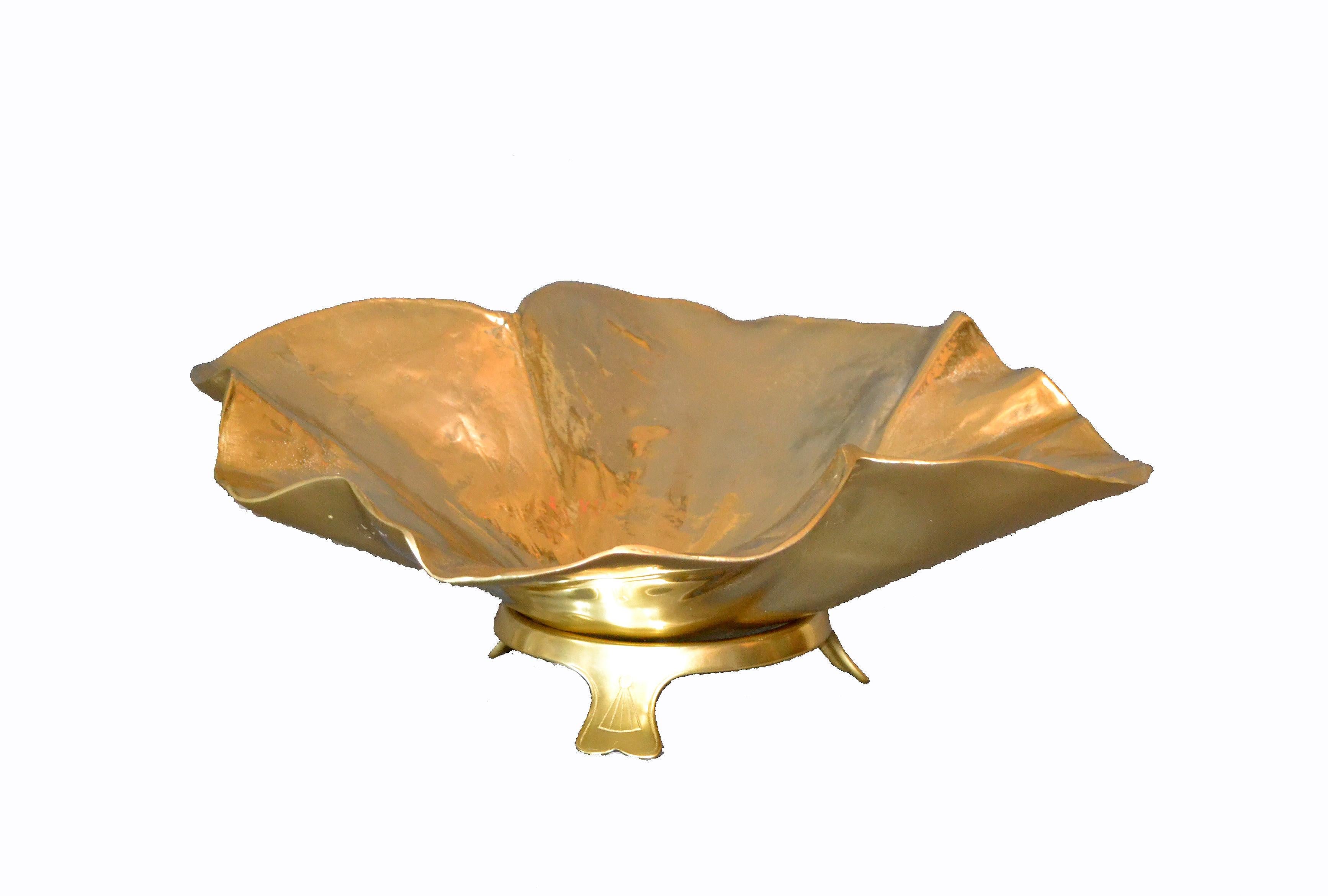 Large handcrafted brass lotus leaf bowl with tri-pot stand by Oskar J.W. Hansen.
Stunning detail with lotus leaf veins and texture. Raised ruffled edge, rounded bottom, fits into its original tri-foot stand .
Makers mark embossed underneath: